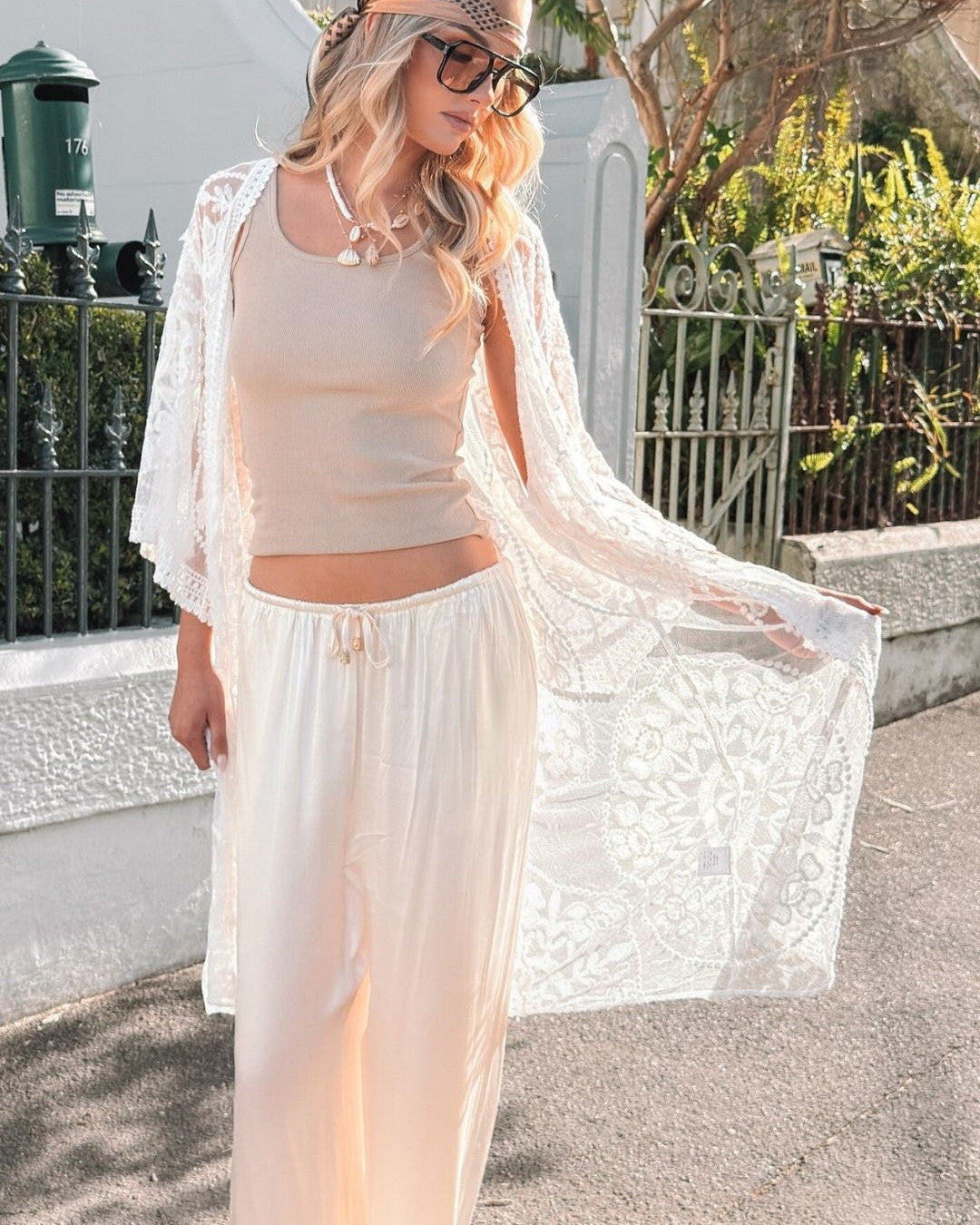 girl posing on couch wearing a bright orange dress