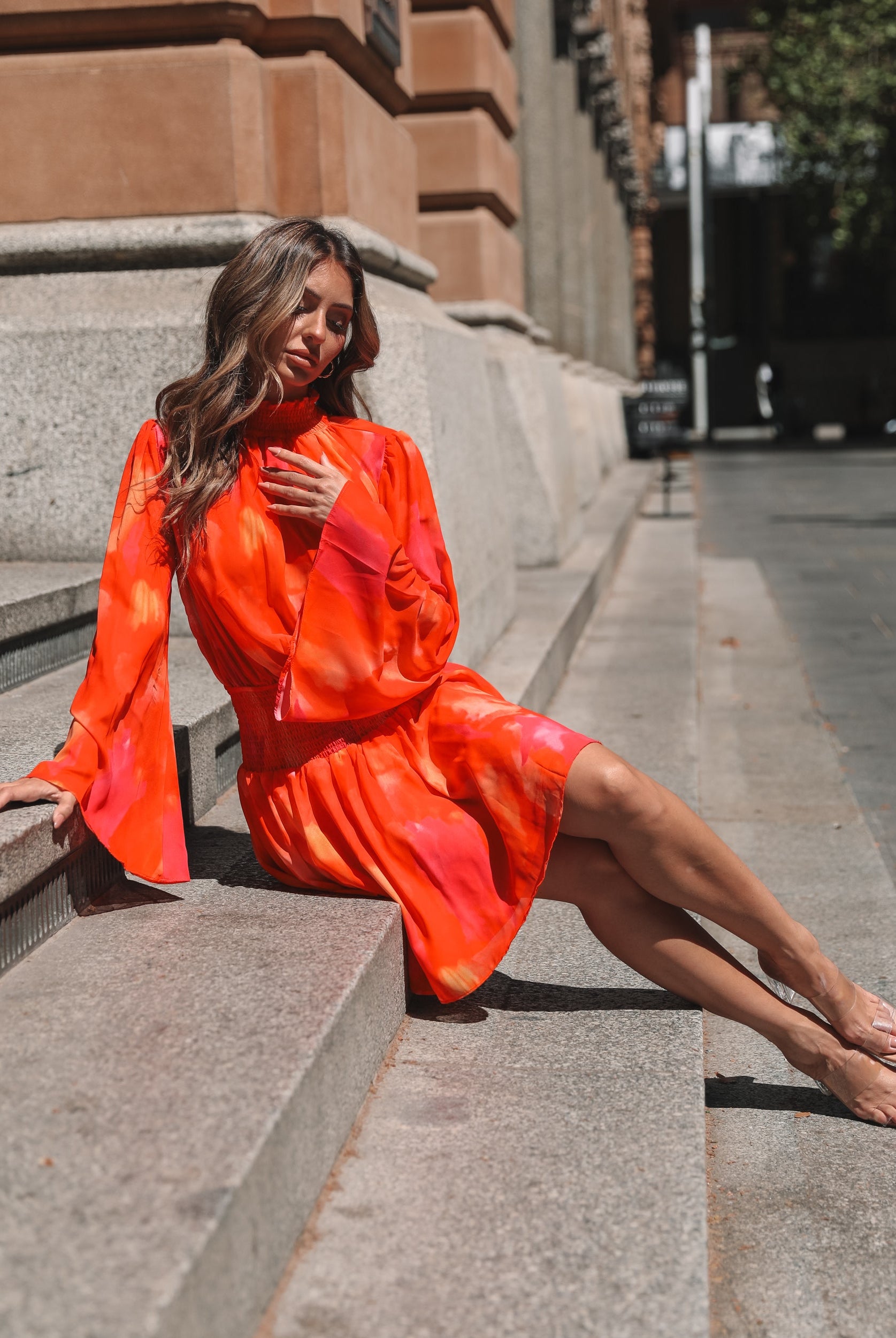 Model wearing the Daenerys Mini Dress in Orange Print showing full outfit styling