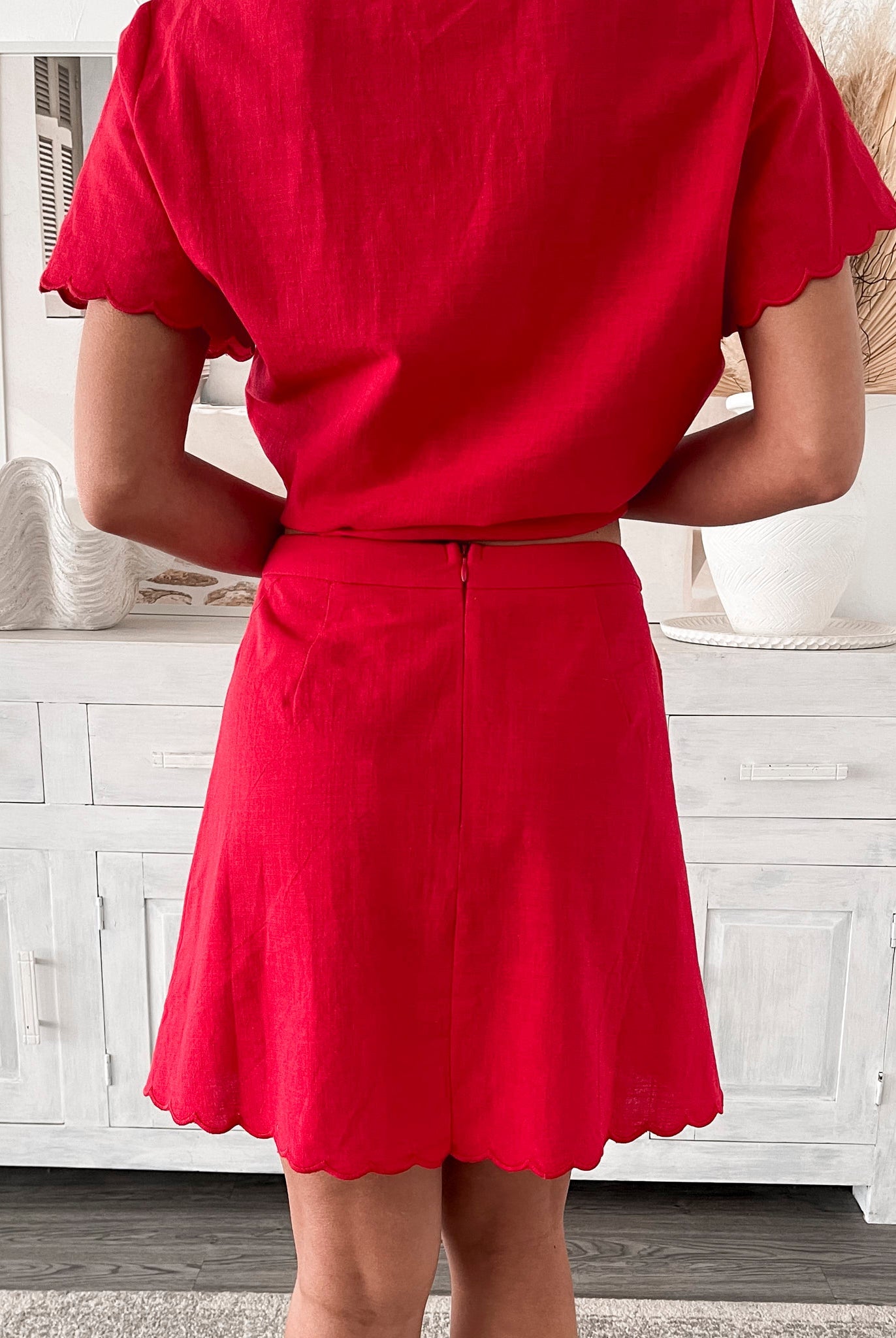 Women's bright red high-waisted mini skirt side view by Esther & Co