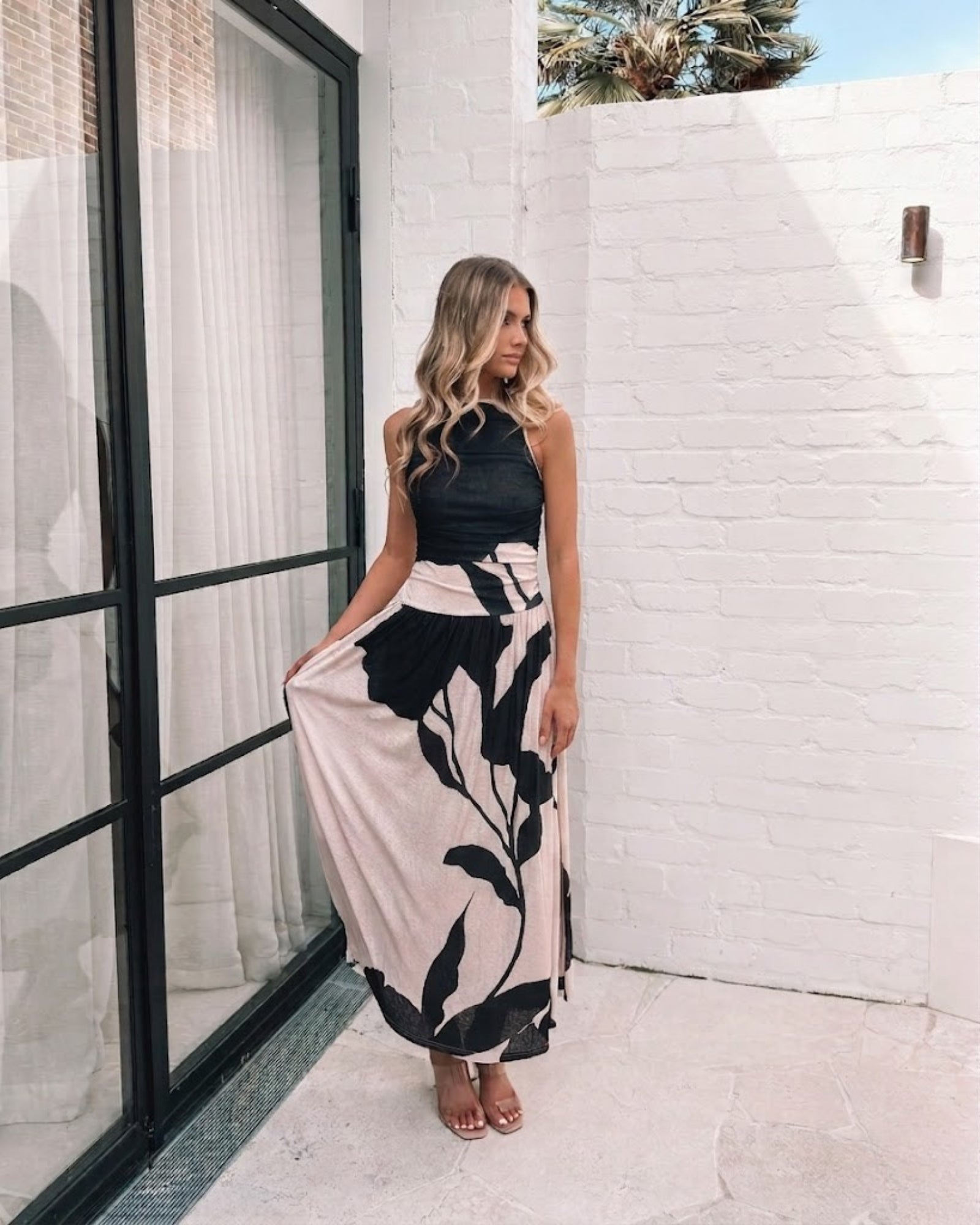Women's flowy mono floral print midi dress styled for evening by Esther & Co