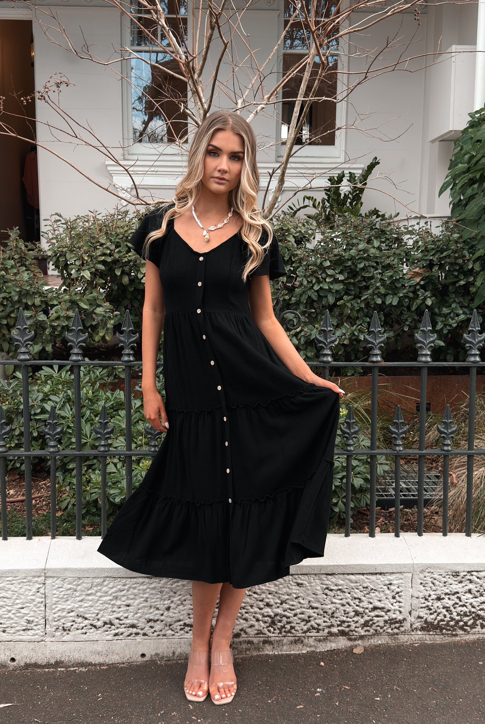 Front view of the Celie Black Linen Midi Dress showing the V-neckline and frill detail
