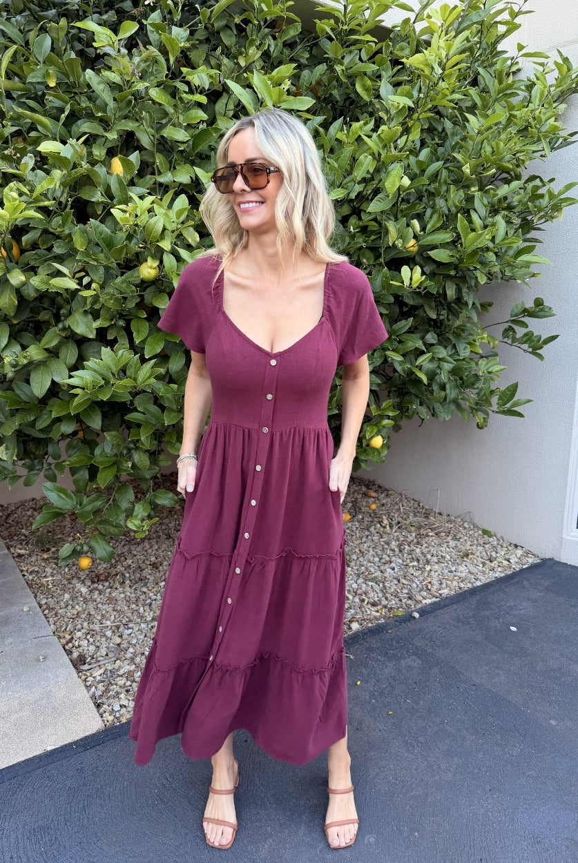 Model wearing the Celie Bordeaux Dress styled with tan sandals for a casual brunch look