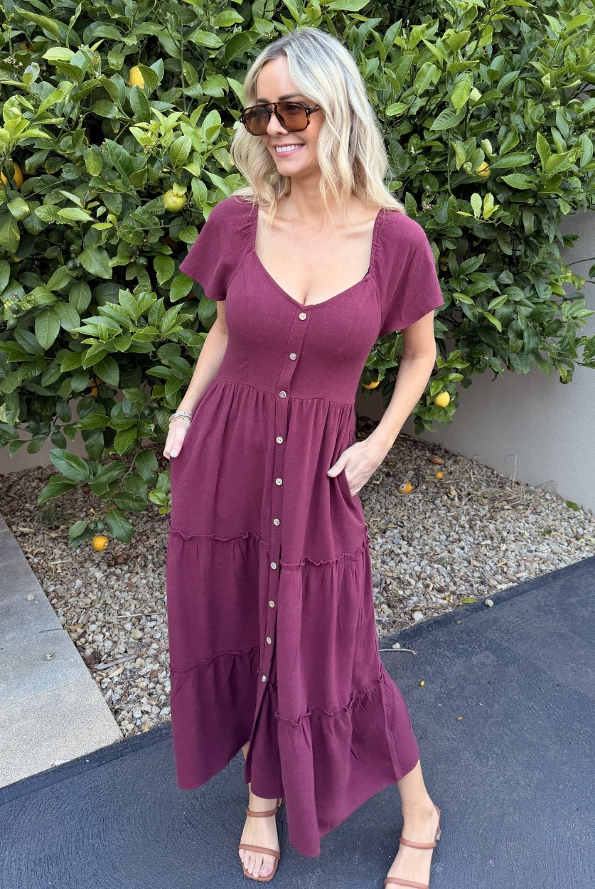 Side view of the Celie Dress in Bordeaux showing the midi length and button-up detail