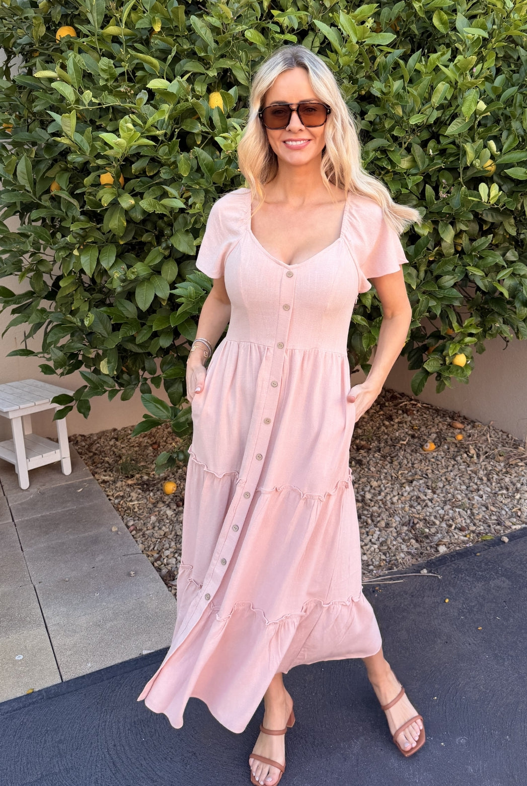 Front view of the Celie Pink Linen Midi Dress showing the V-neckline and flowing A-line silhouette