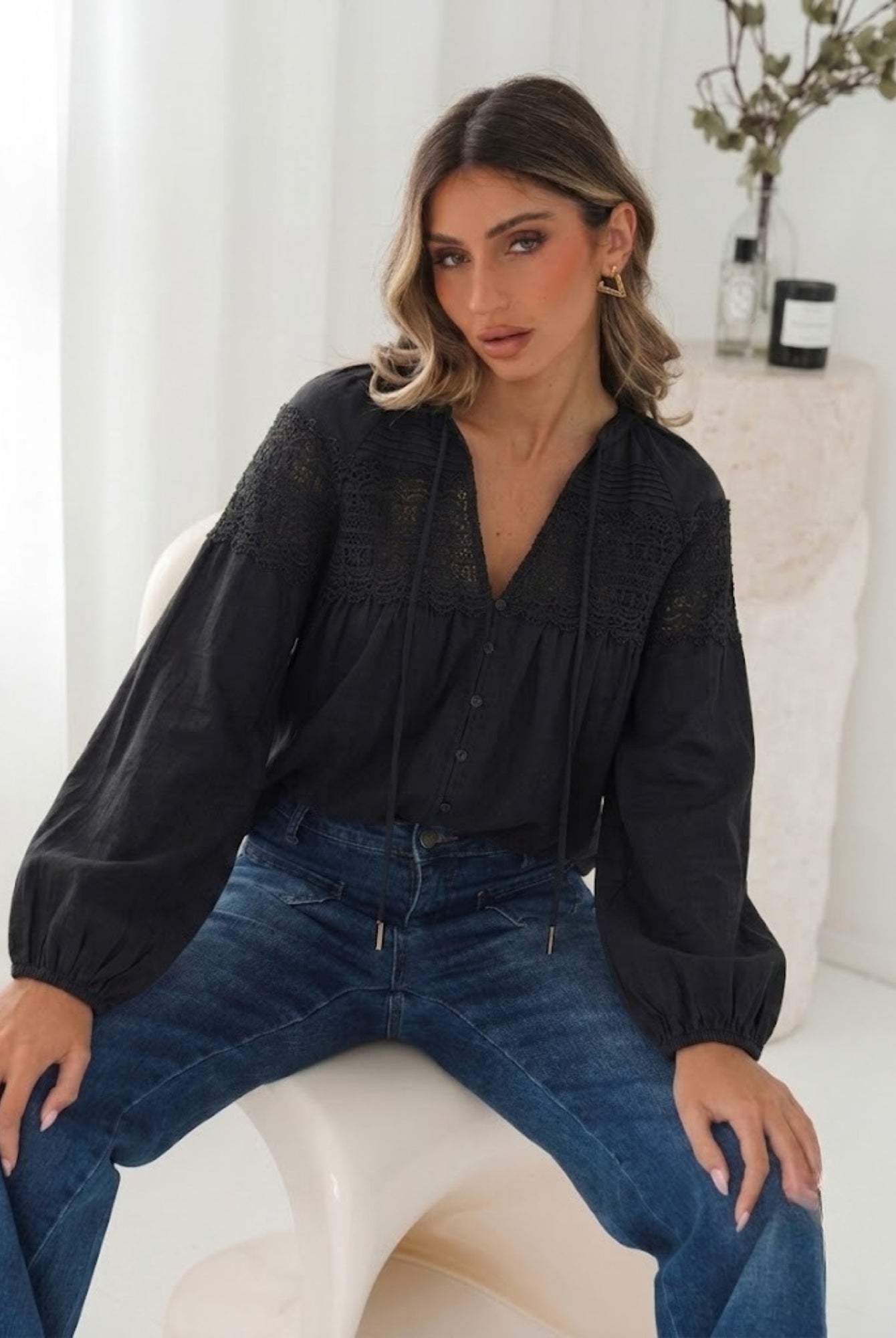 Women's black lace blouse with V neckline and balloon sleeves, the Chenille Blouse in Black Lace by Esther & Co