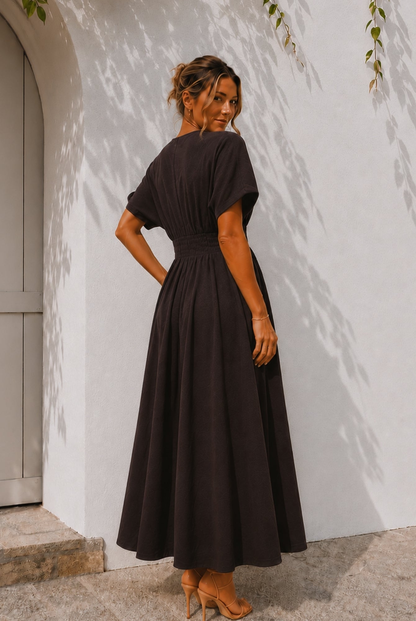 Women's chocolate brown pleated maxi dress with gold statement buttons, the Clairice Dress in Choco by Esther & Co