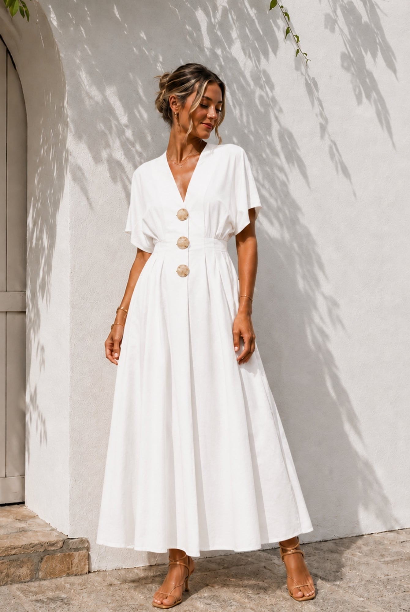 Women's white pleated maxi dress with statement front buttons, the Clairice Dress in White by Esther & Co