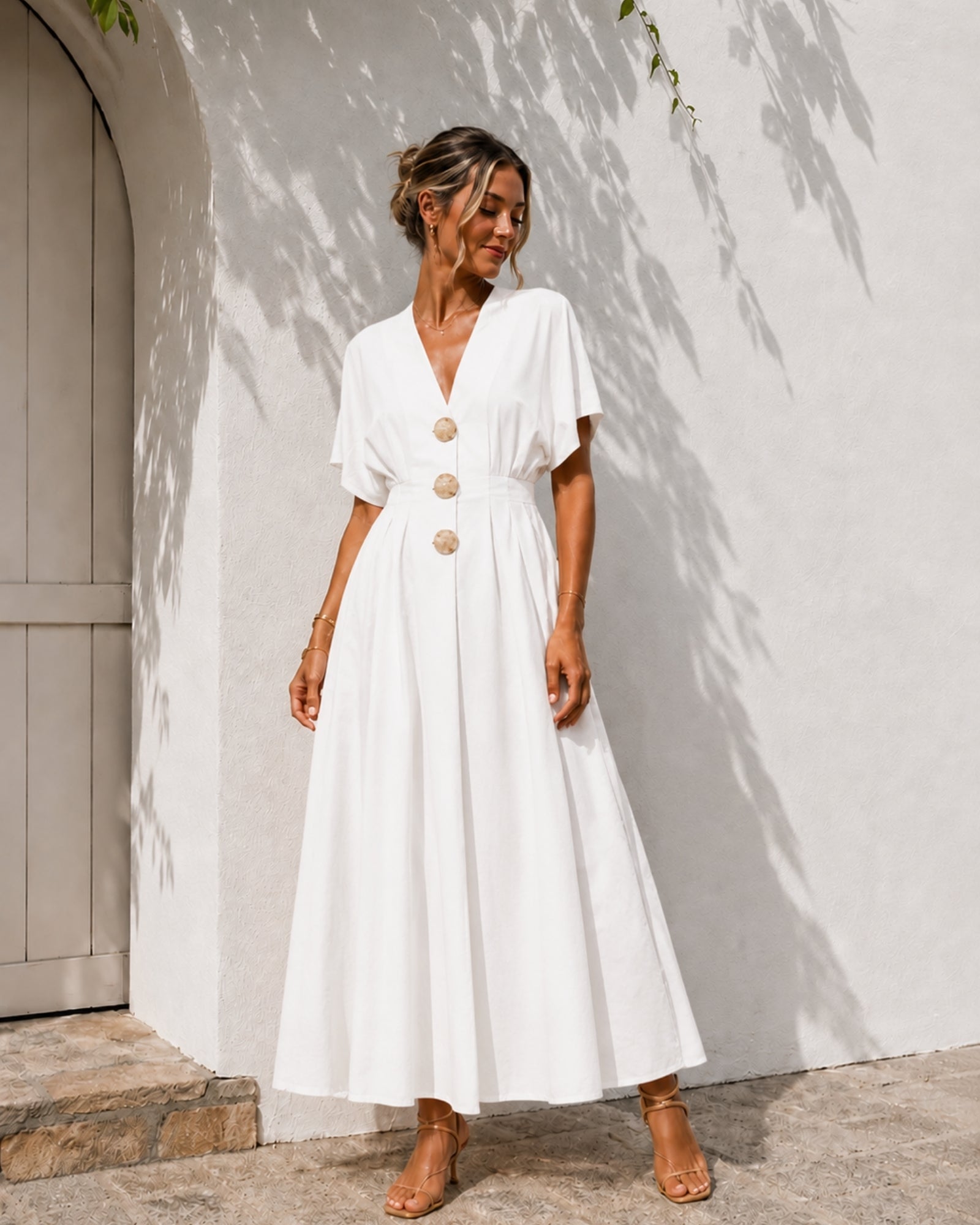 Women's white pleated maxi dress with statement front buttons, the Clairice Dress in White by Esther & Co