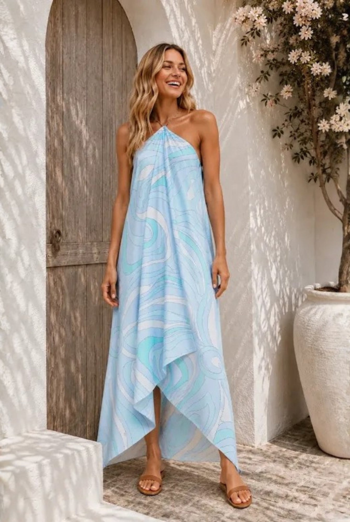 Women's blue halter neck maxi dress with asymmetrical hem, the Clairol Dress in Coastal Swirl by Esther & Co