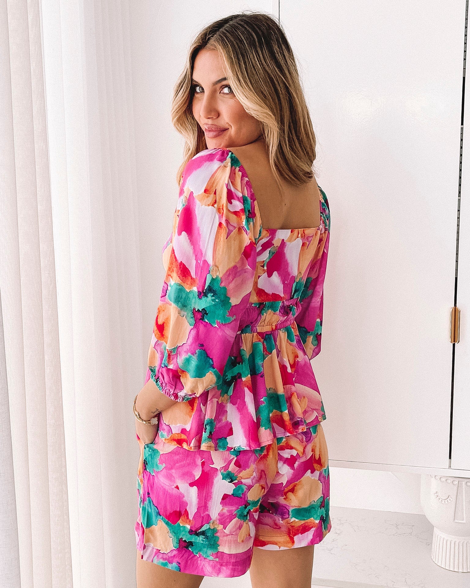 Women's pink floral print peplum top with bubble sleeves by Esther & Co