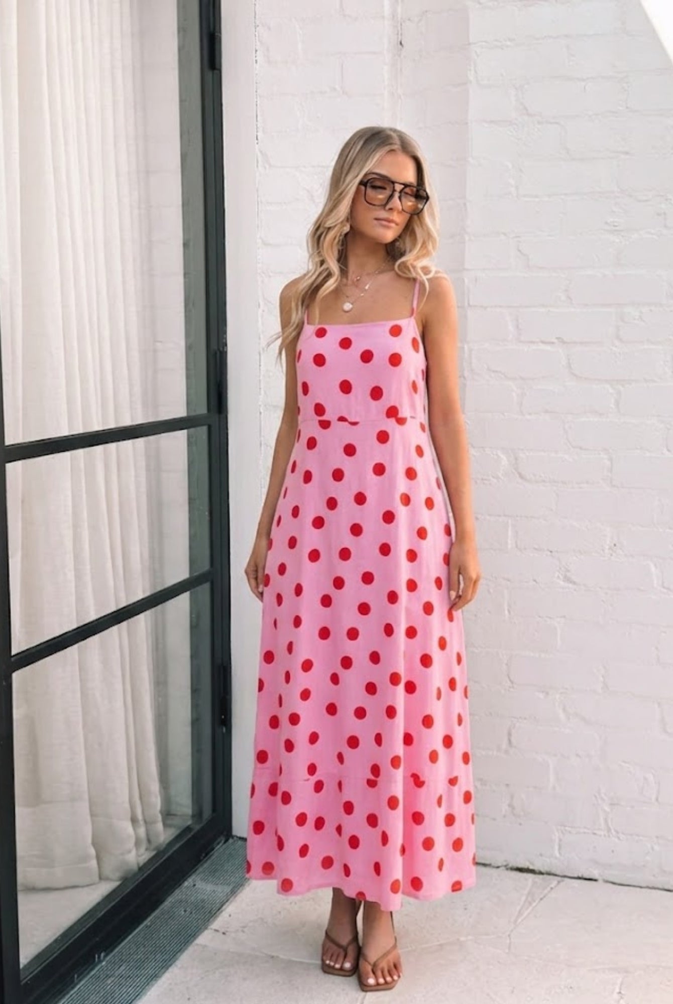 Women's pink polka dot midi dress styled outfit by Esther & Co