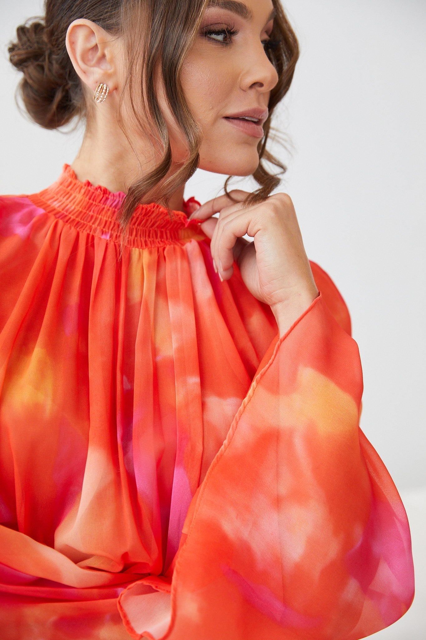 Close up detail of the Daenerys Mini Dress in Orange Print showing the vibrant red and purple print on orange base
