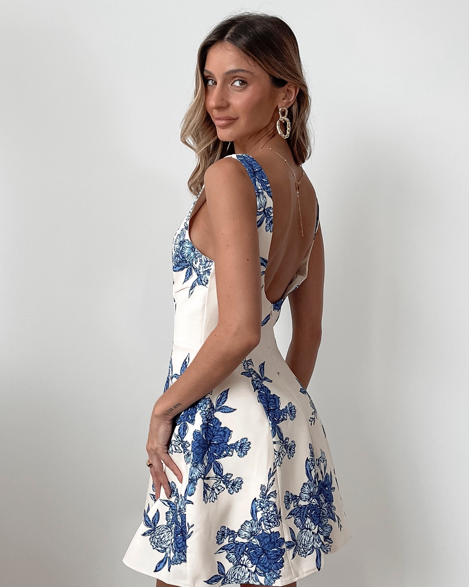 Women's white blue floral print mini dress styled for an event by Esther & Co