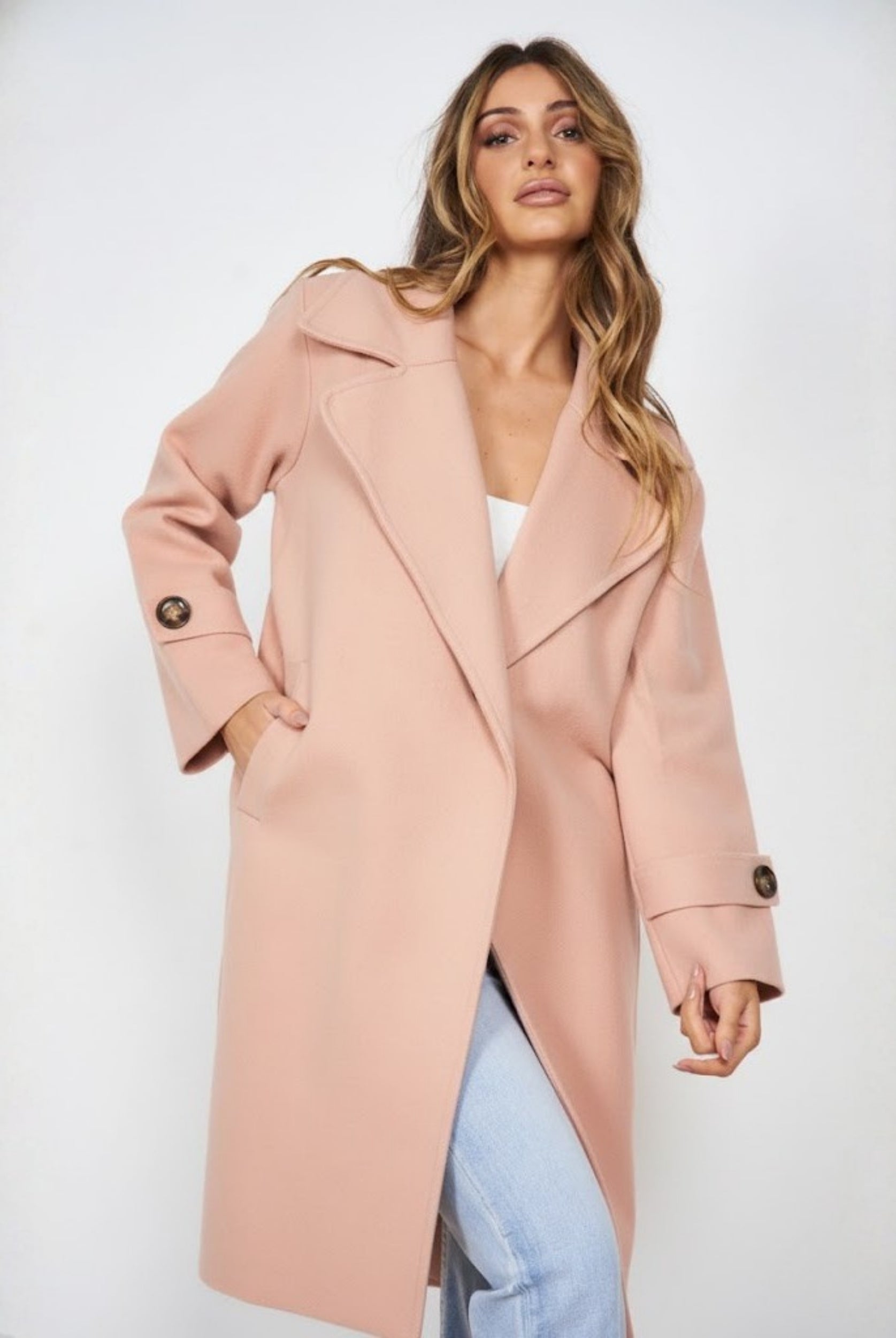 Women wearing the Fireplace Coat in Pink, a soft medium-weight knit trench coat with open-front silhouette