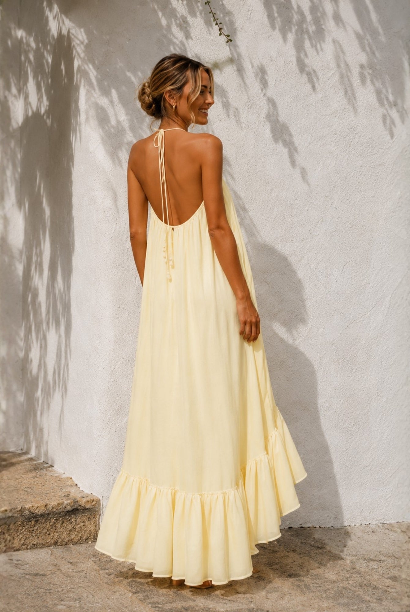 Women's pastel yellow halter neck high low maxi dress, the Flynne Dress in Sunrise Glow by Esther & Co