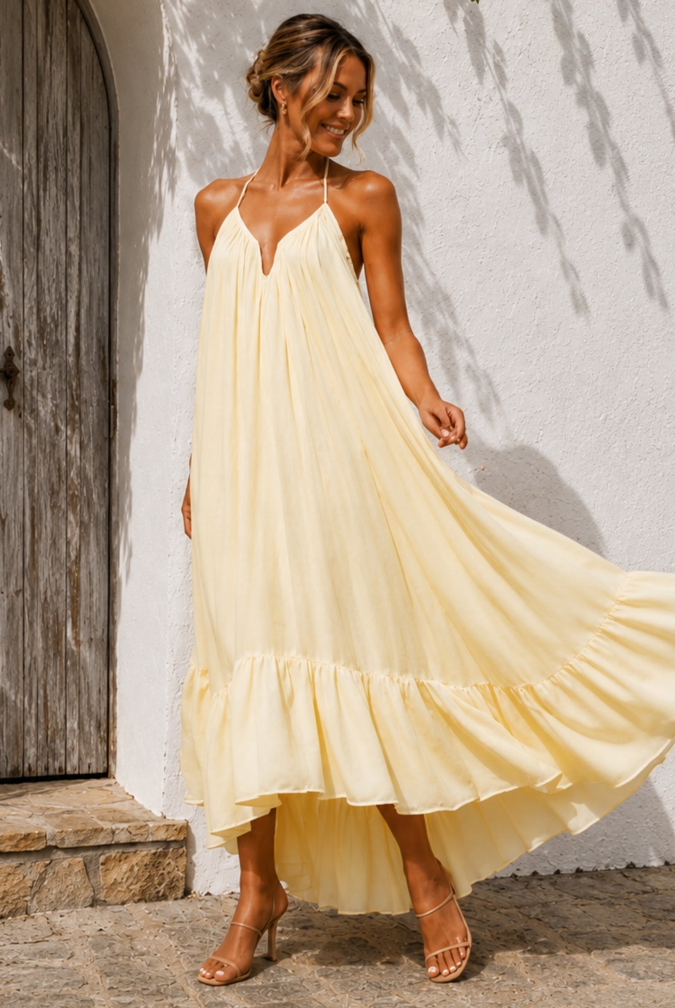 Women's pastel yellow halter neck high low maxi dress, the Flynne Dress in Sunrise Glow by Esther & Co