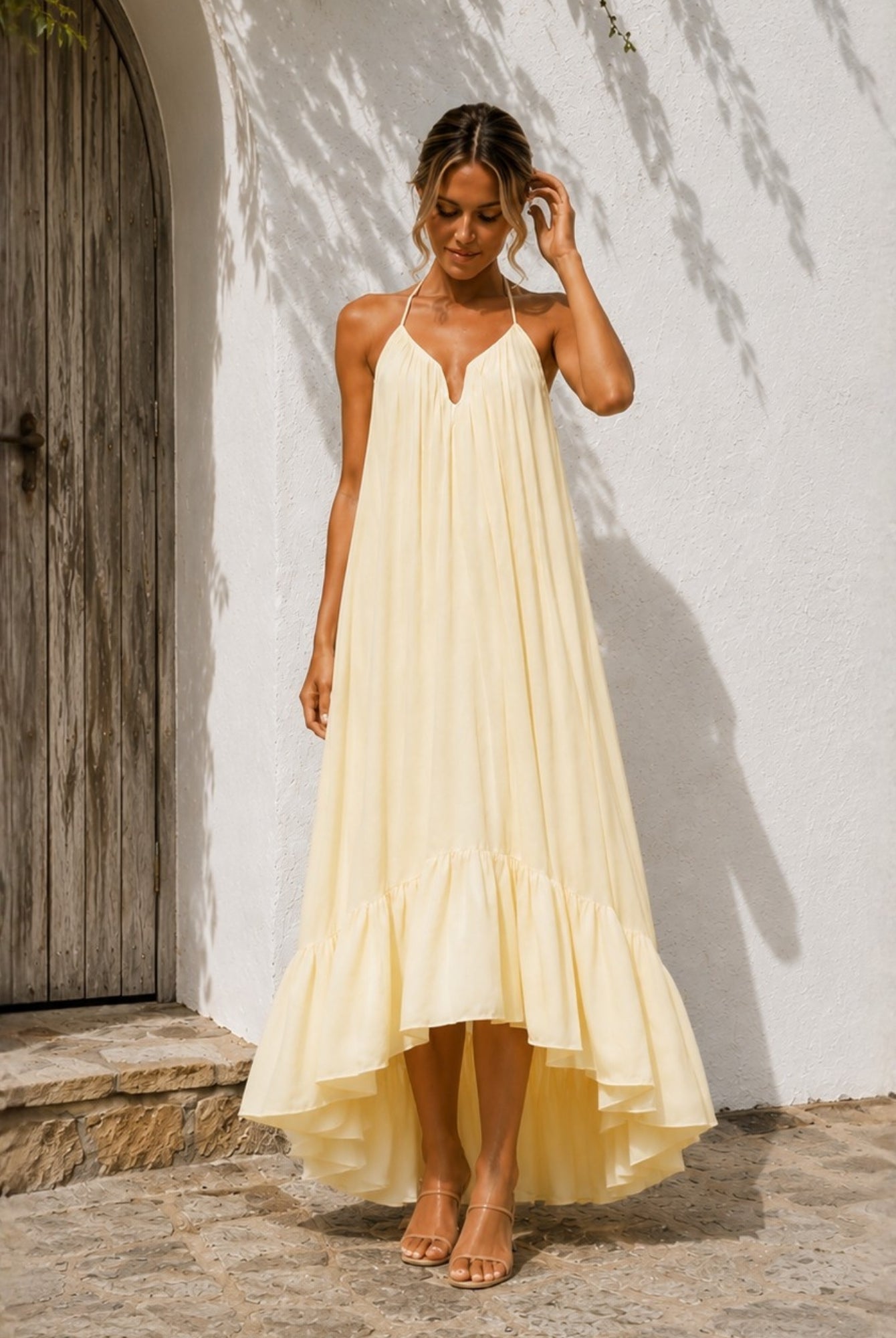 Women's pastel yellow halter neck maxi dress front view, the Flynne Dress in Sunrise Glow by Esther & Co