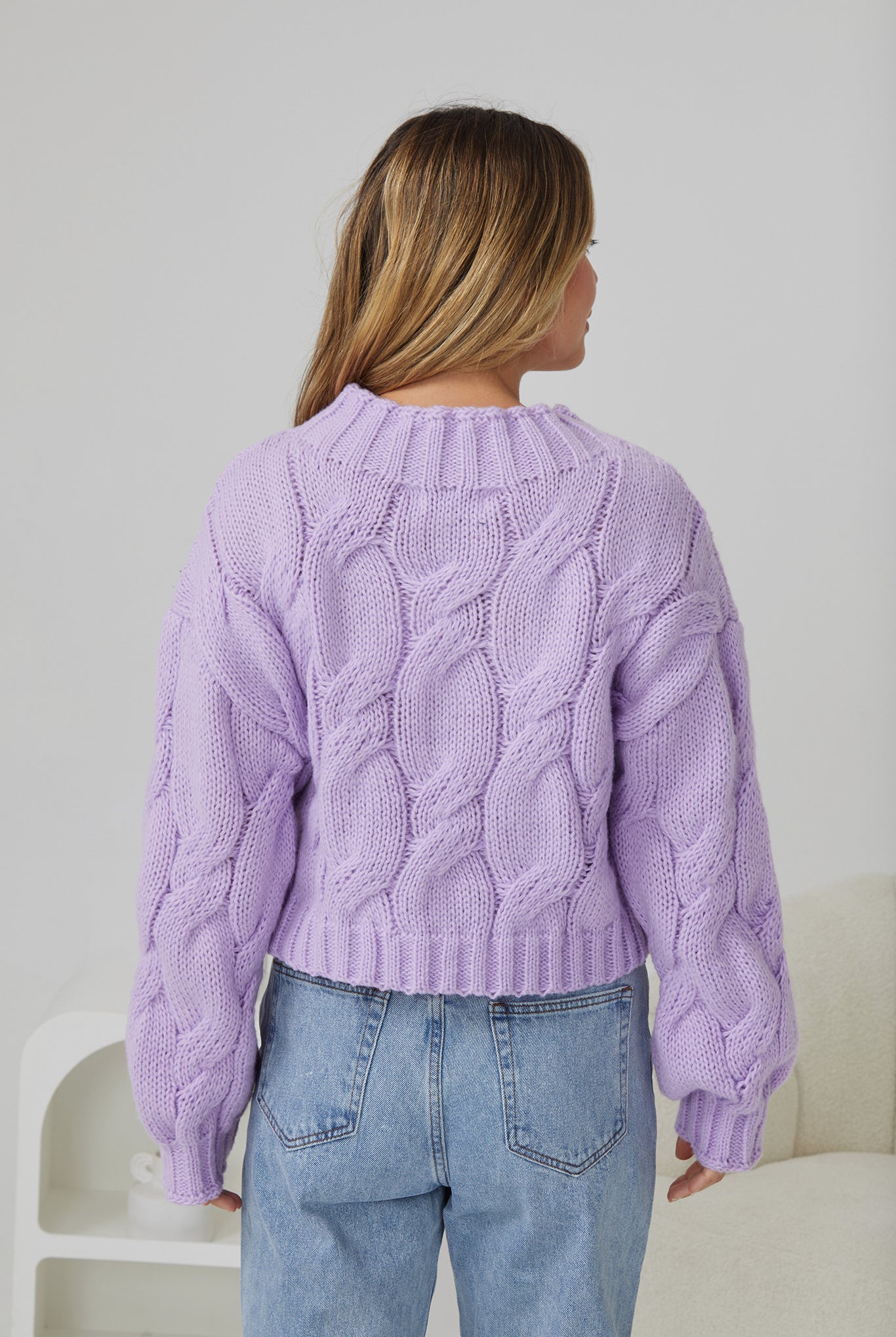 Model wearing the Hadi Lilac Knit Jumper tucked into a midi skirt with boots for an elevated winter look