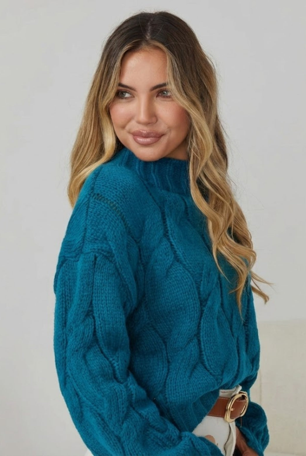 Front view of the Hadi Teal Knit showing the high round neckline and textured knit fabric