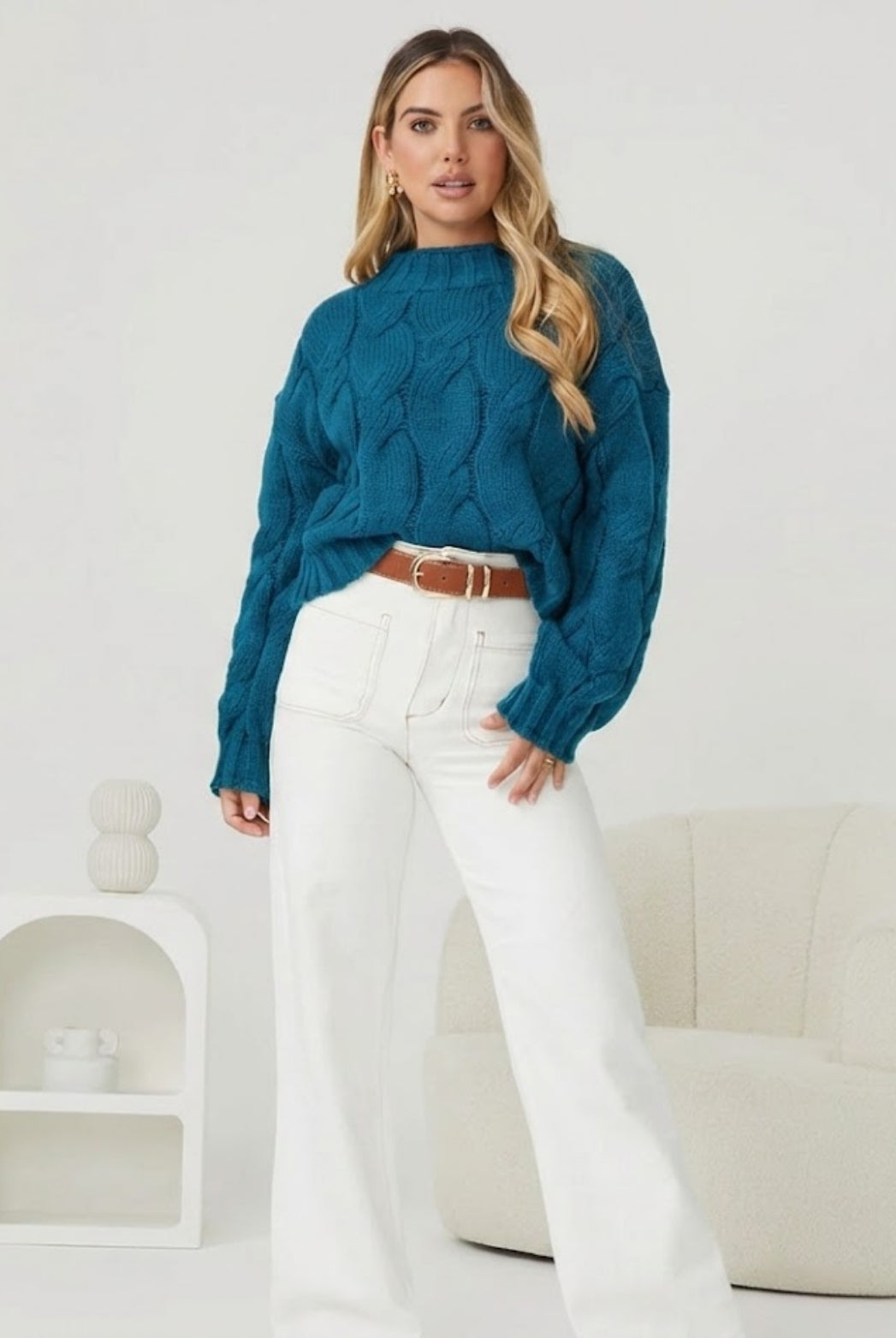 Side view of the Hadi Knit in Teal showing the long sleeves and relaxed fit