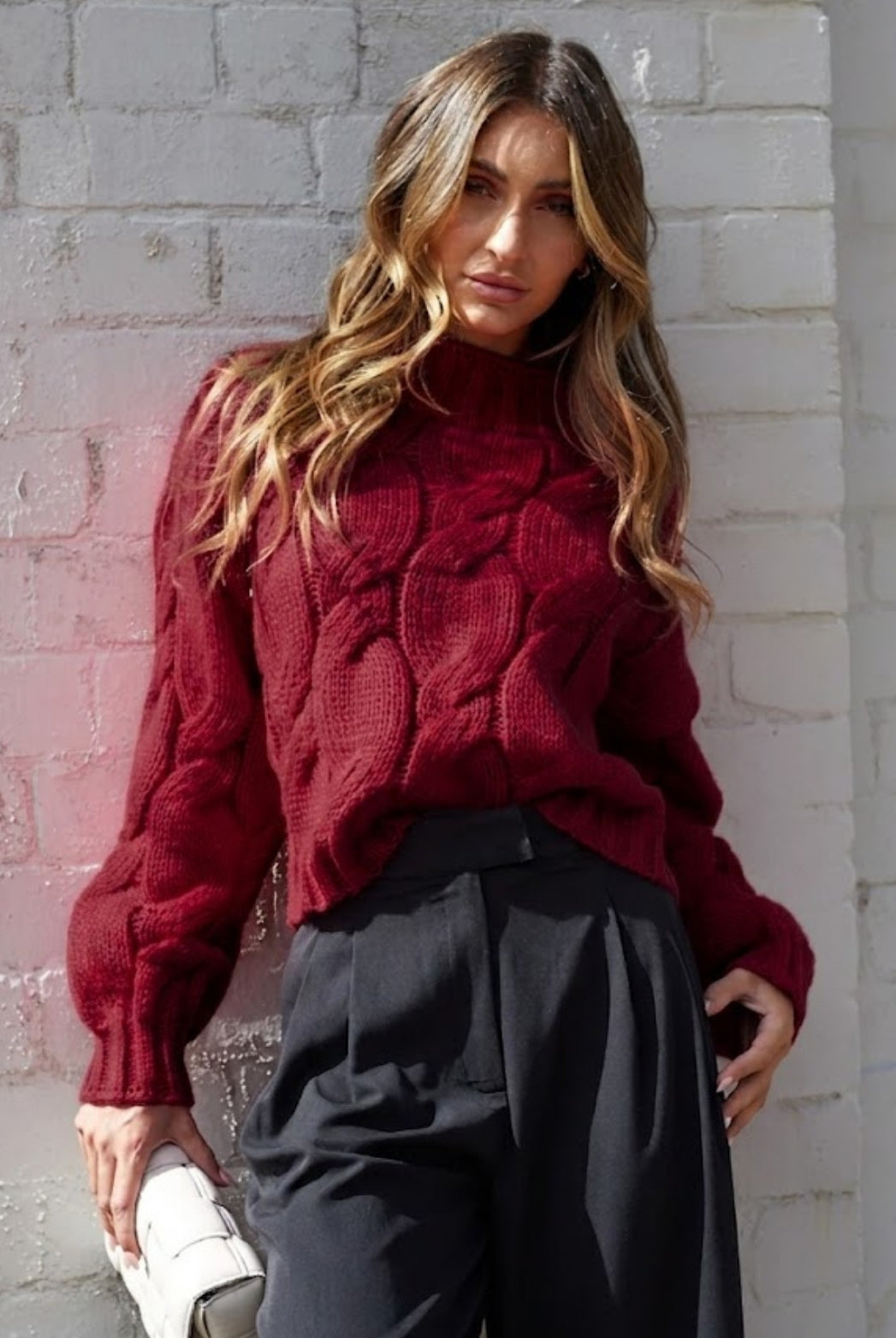 Women wearing the Hadi Knit in Wine, a cosy acrylic women's jumper with high round neckline and long sleeves