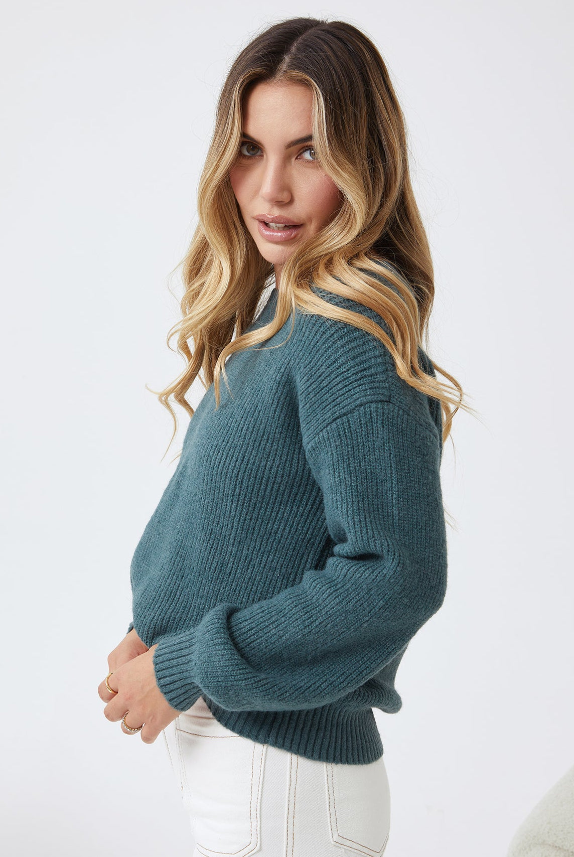 Side view of the Harvie Knit in Petrol showing the longline silhouette and cosy wool blend fabric