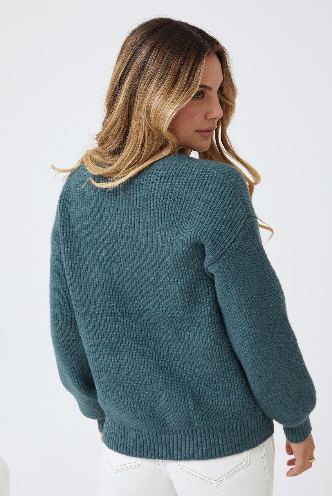 Model wearing the Harvie Petrol Knit Jumper with straight leg jeans and ankle boots for a casual street style look