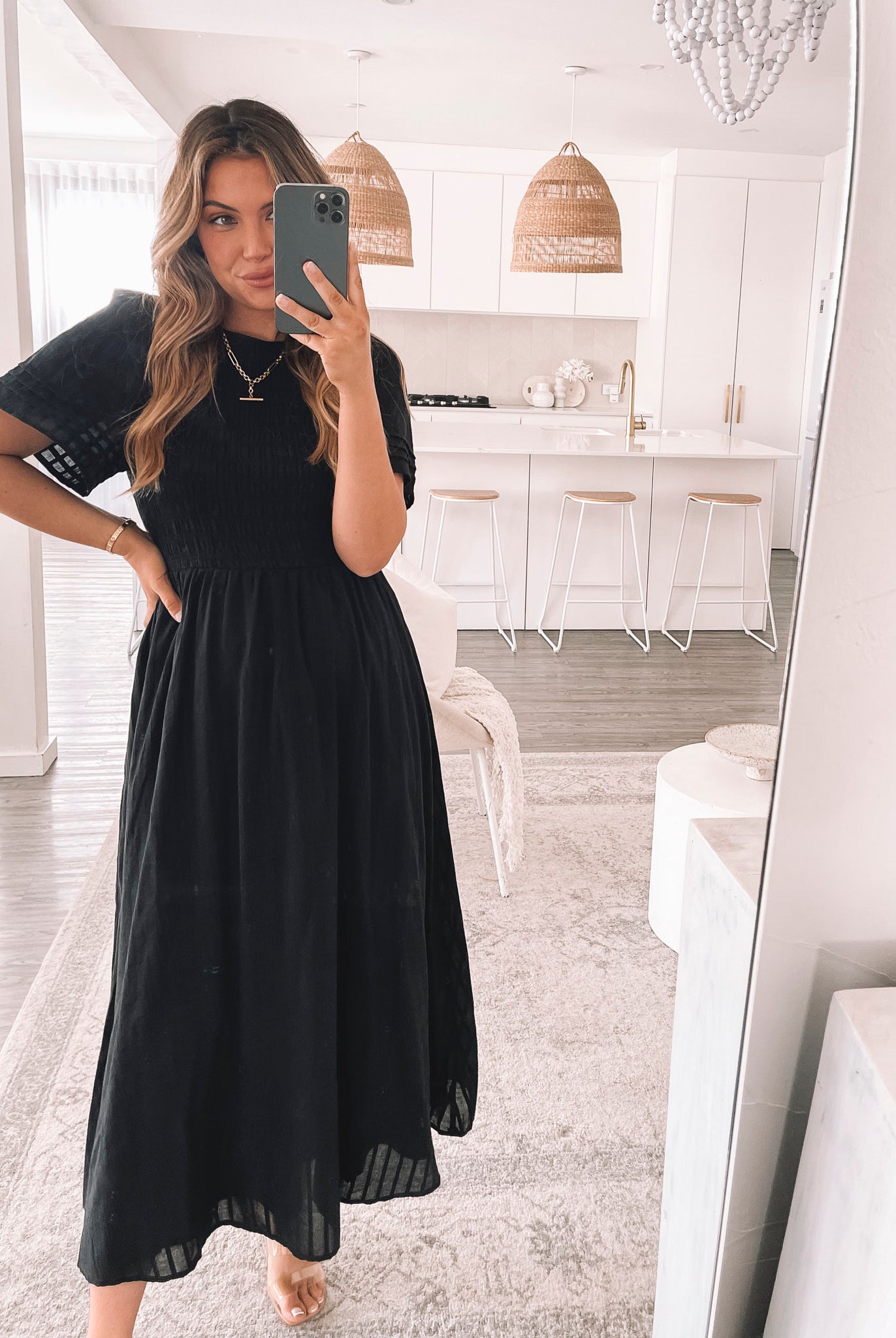 Model wearing the Iolana Dress in Black styled with heeled mules and gold jewellery