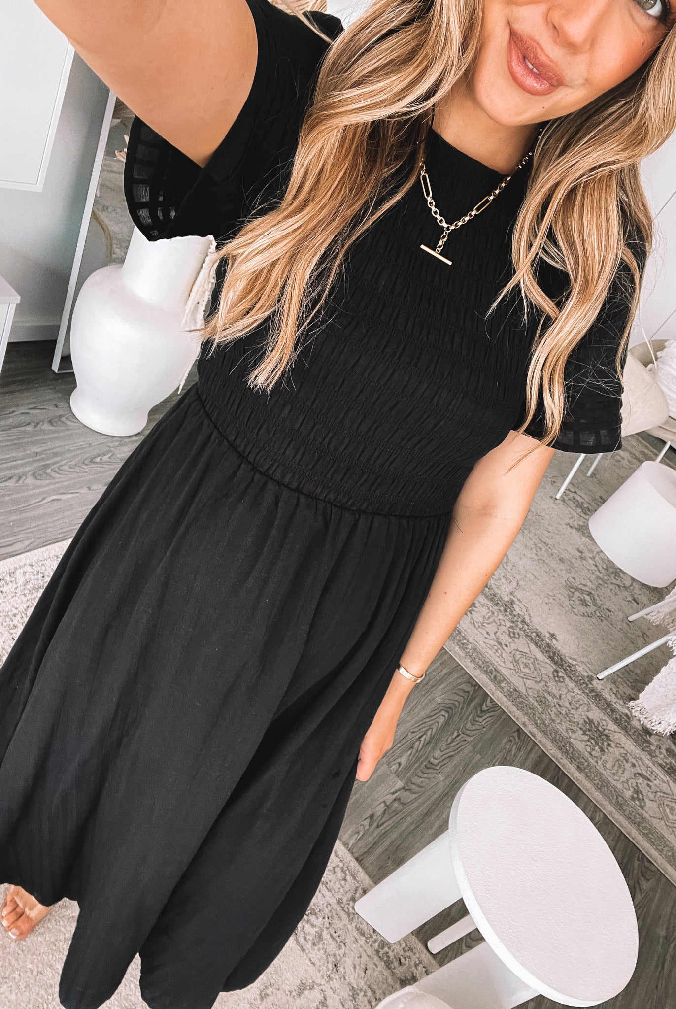 Full length view of the Iolana Dress in Black showing the flattering midi length and relaxed fit