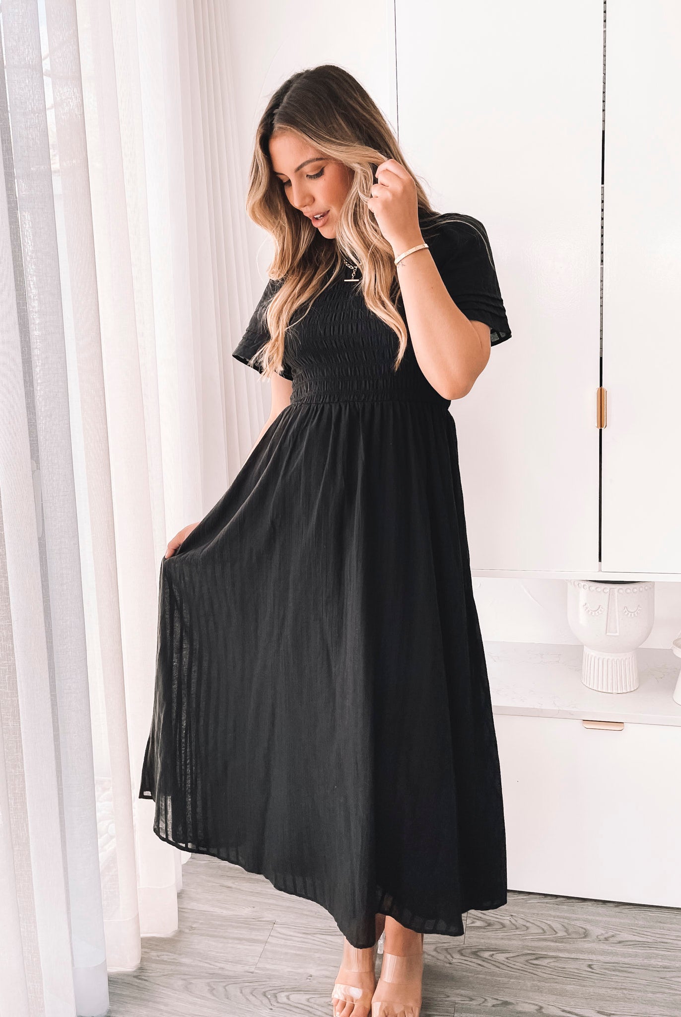 Front view of the Iolana Black Midi Dress showing the A-line silhouette and smocked bodice