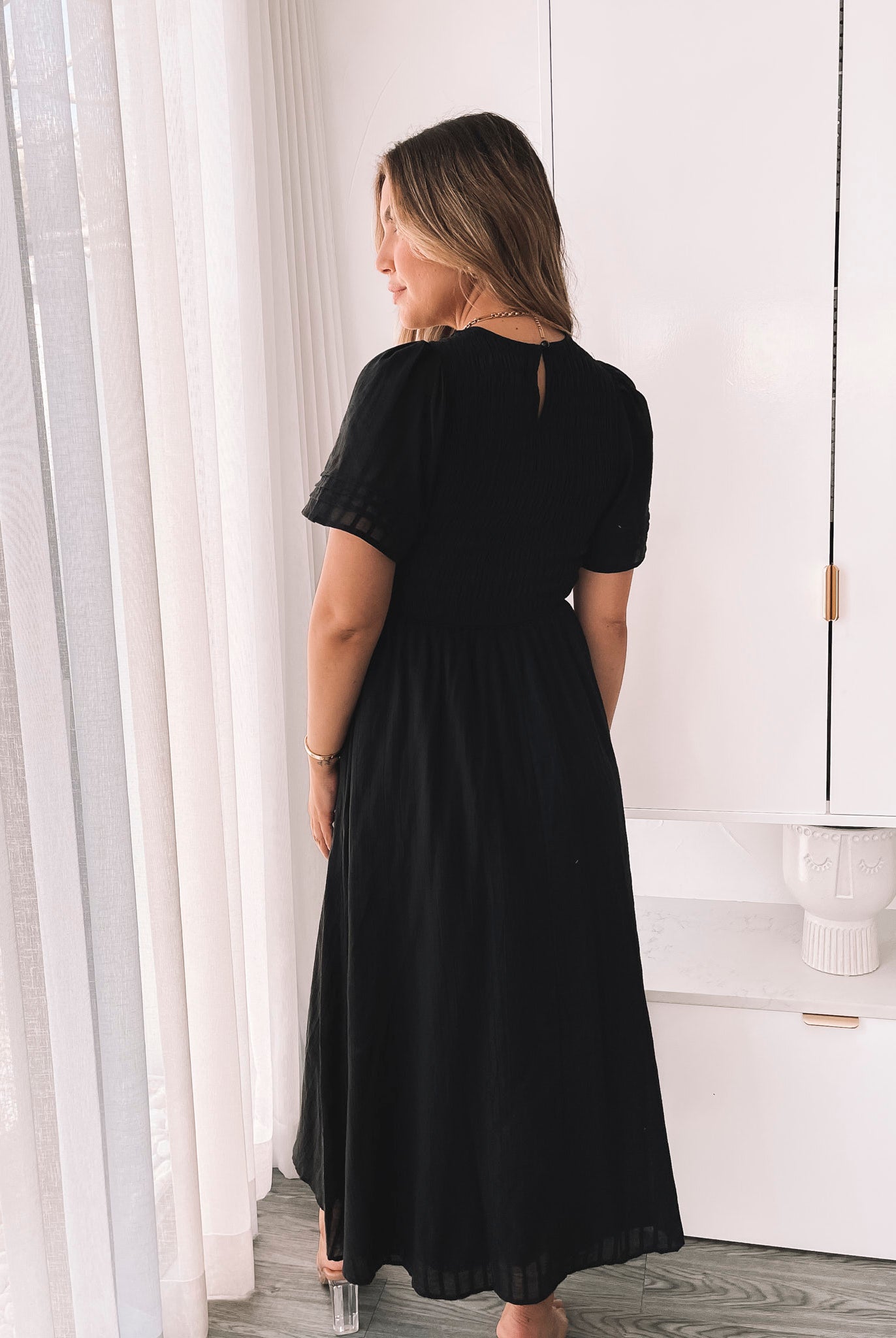 Back view of the Iolana Black Smock Midi Dress by Esther and Co