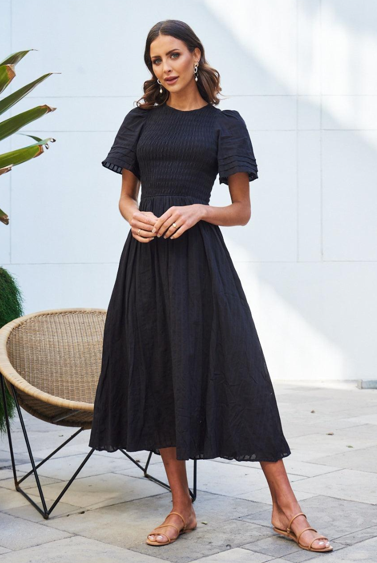 Flat lay of the Iolana Black Smock Midi Dress showing the round neckline and cotton fabric detail
