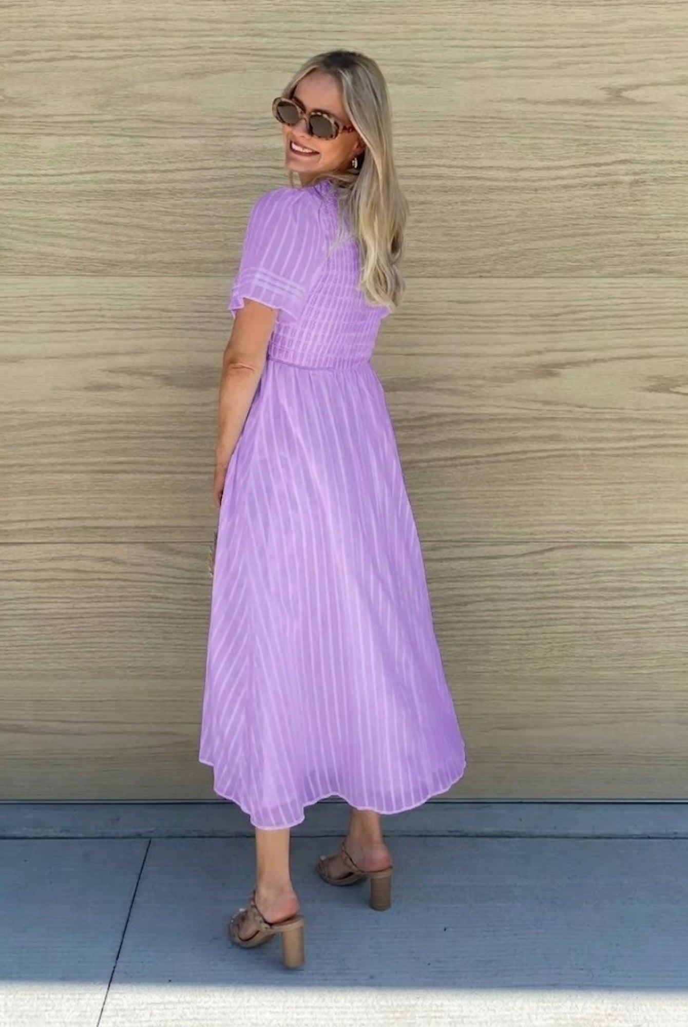 Women's flowy lavender cotton dress styled for a garden party by Esther & Co
