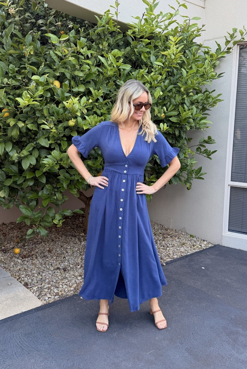 Model wearing the Korbela Navy Midi Dress styled with white sneakers for a casual everyday look