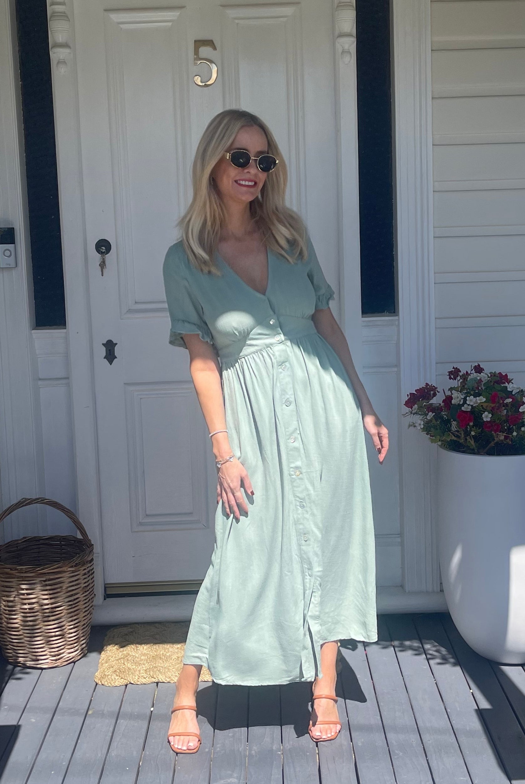 Full length view of the Korbela Dress in Sage showing the relaxed midi length and breathable linen fabric
