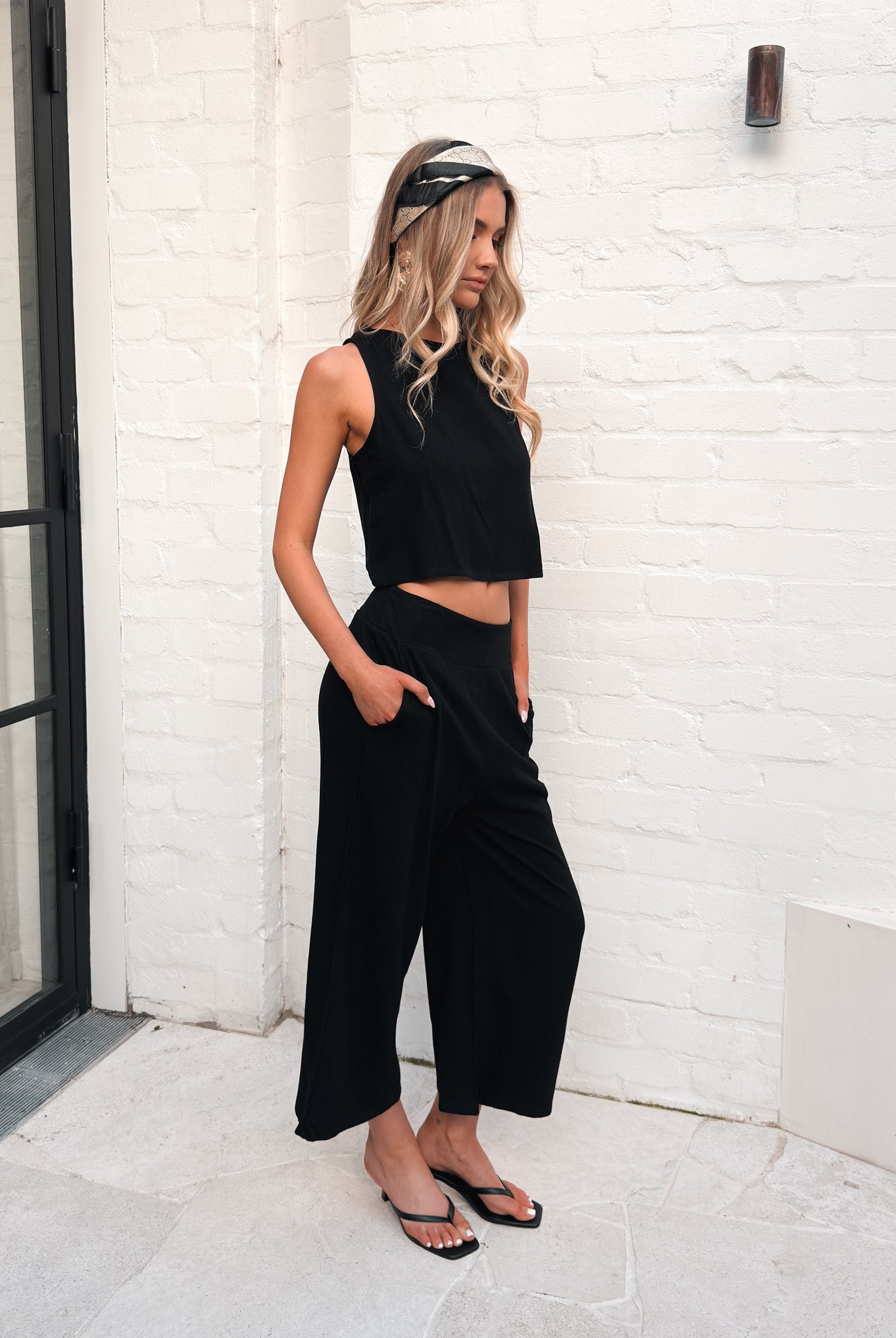 Women's high waisted black linen wide leg pants styled for everyday wear by Esther & Co