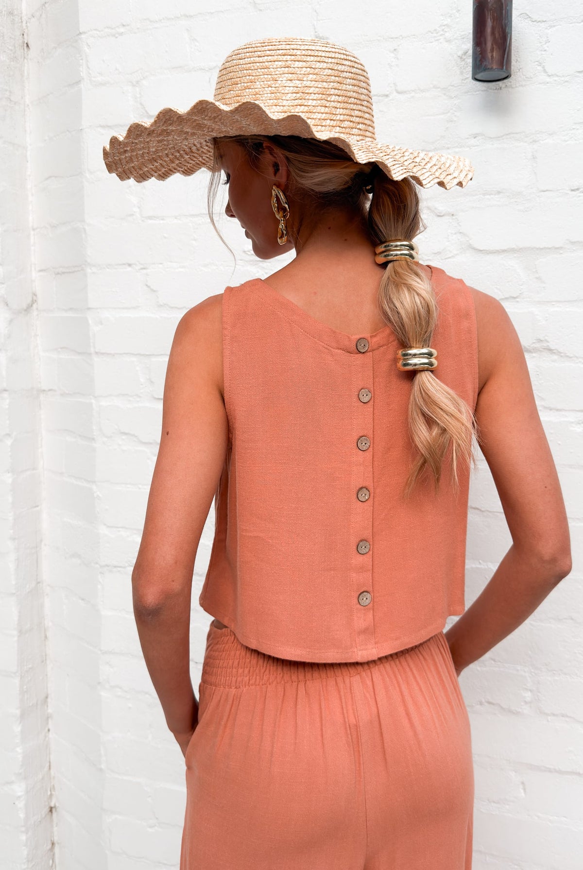 Back view of the women's rust linen crop top showing the button up detail by Esther & Co