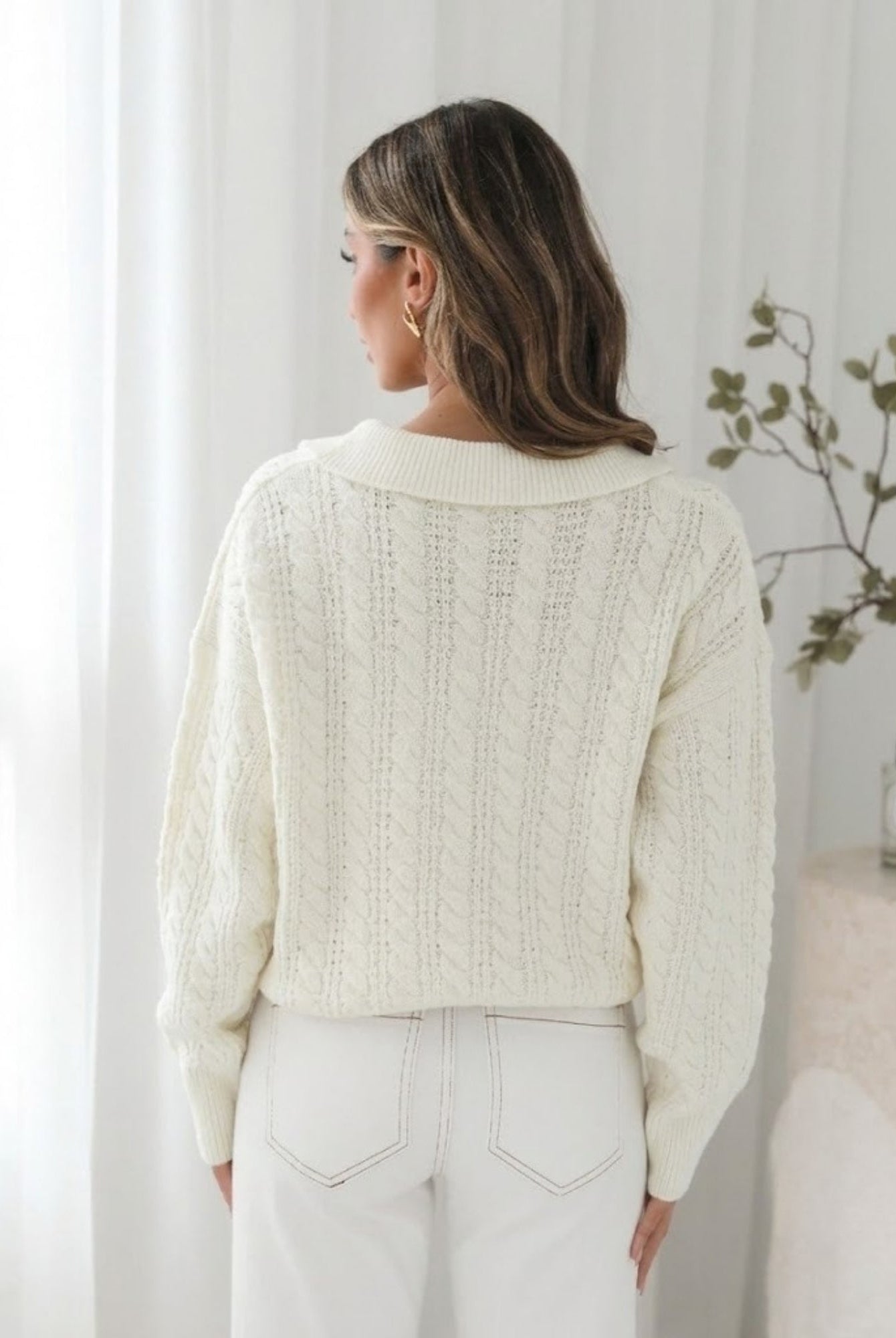 Close-up of cream cable knit and ribbed cuff
