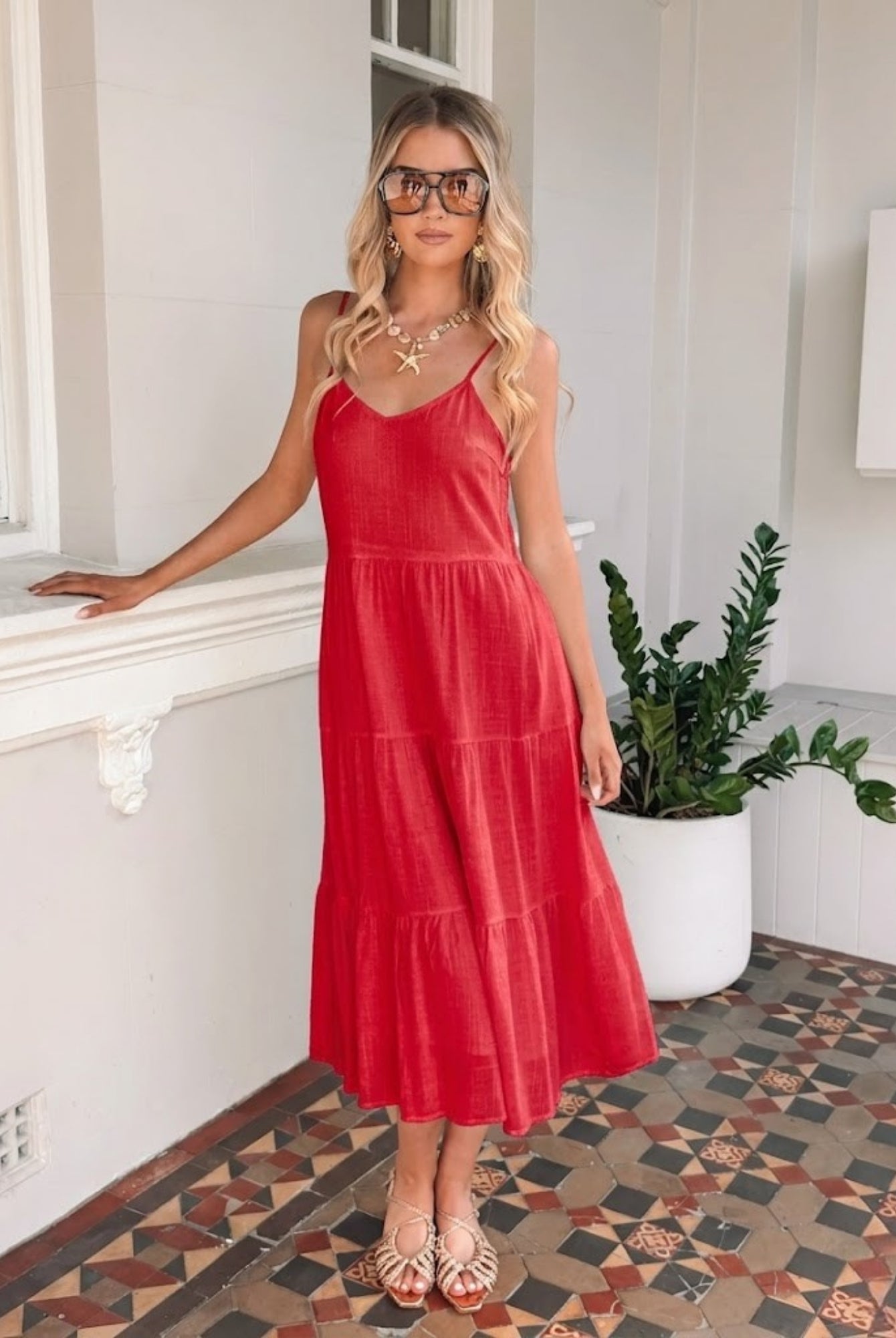 Sonya cherry red linen midi dress with V neckline and adjustable straps, side view