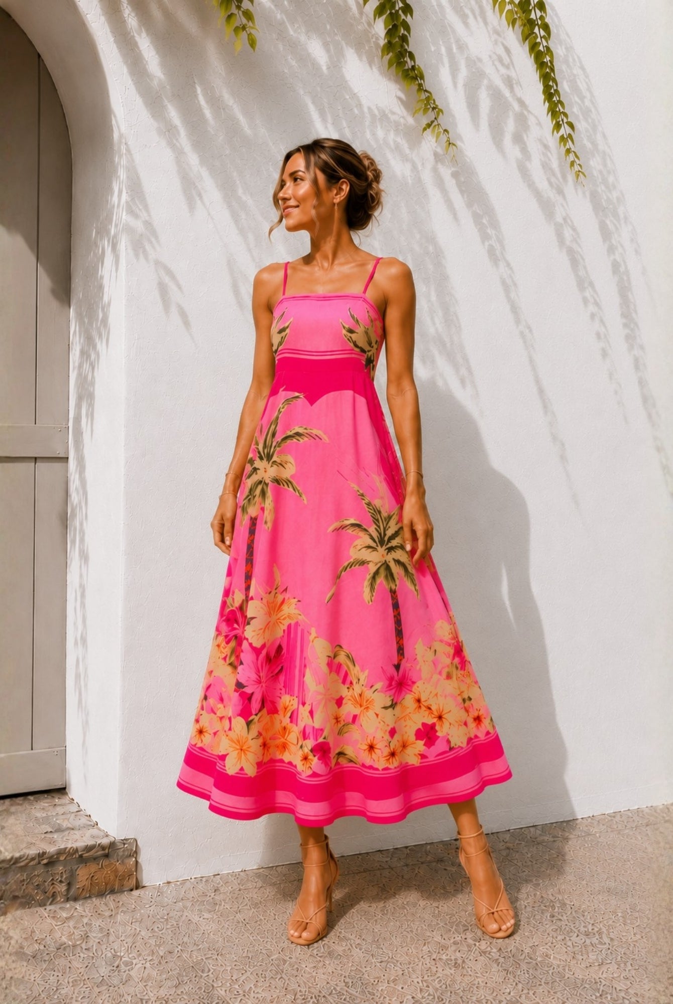 Women's pink tropical print A-line midi dress with palm print border hem, the Welcie Dress in Tropical Bliss by Esther & Co