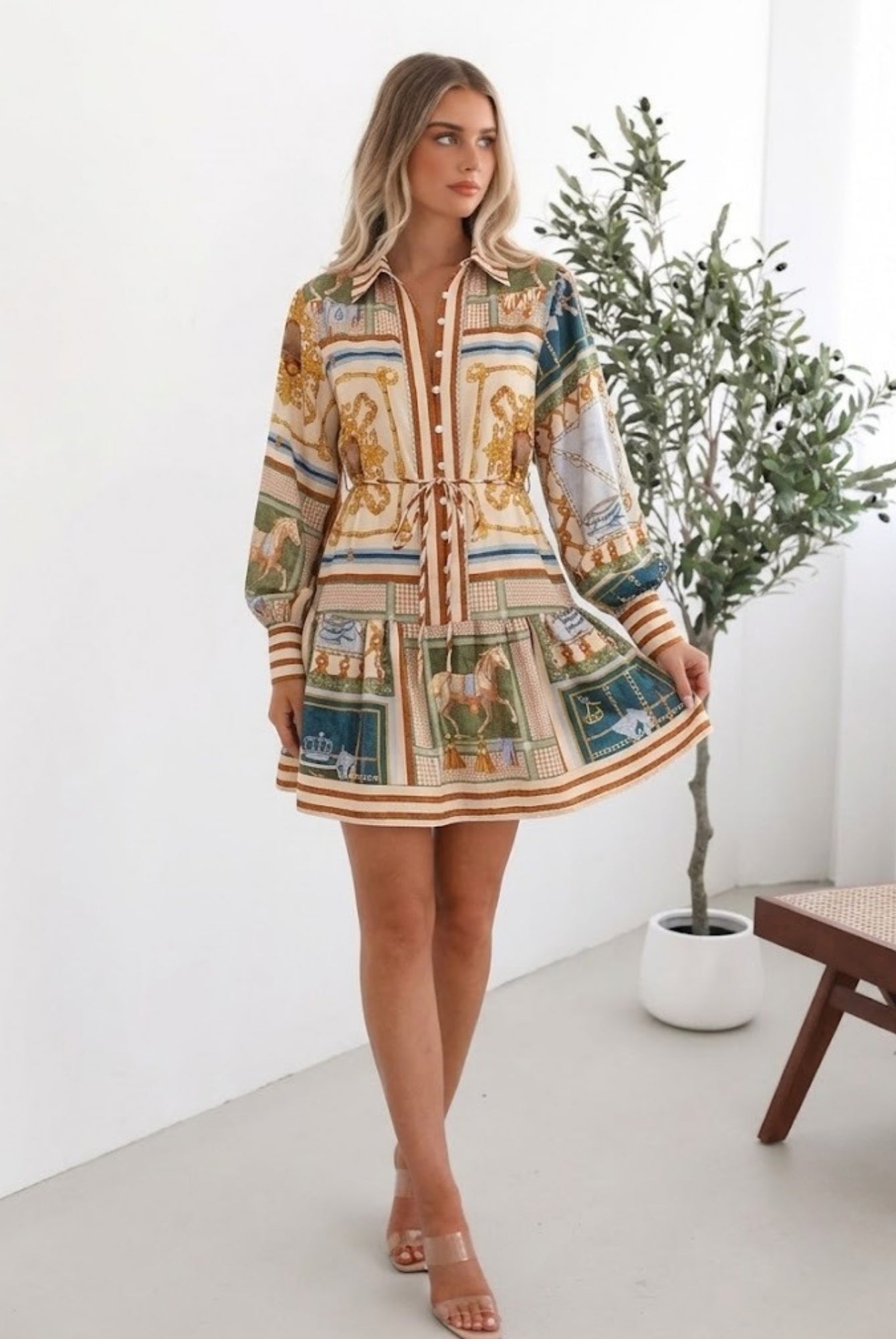 Women's bold print tiered mini dress styled for brunch by Esther & Co