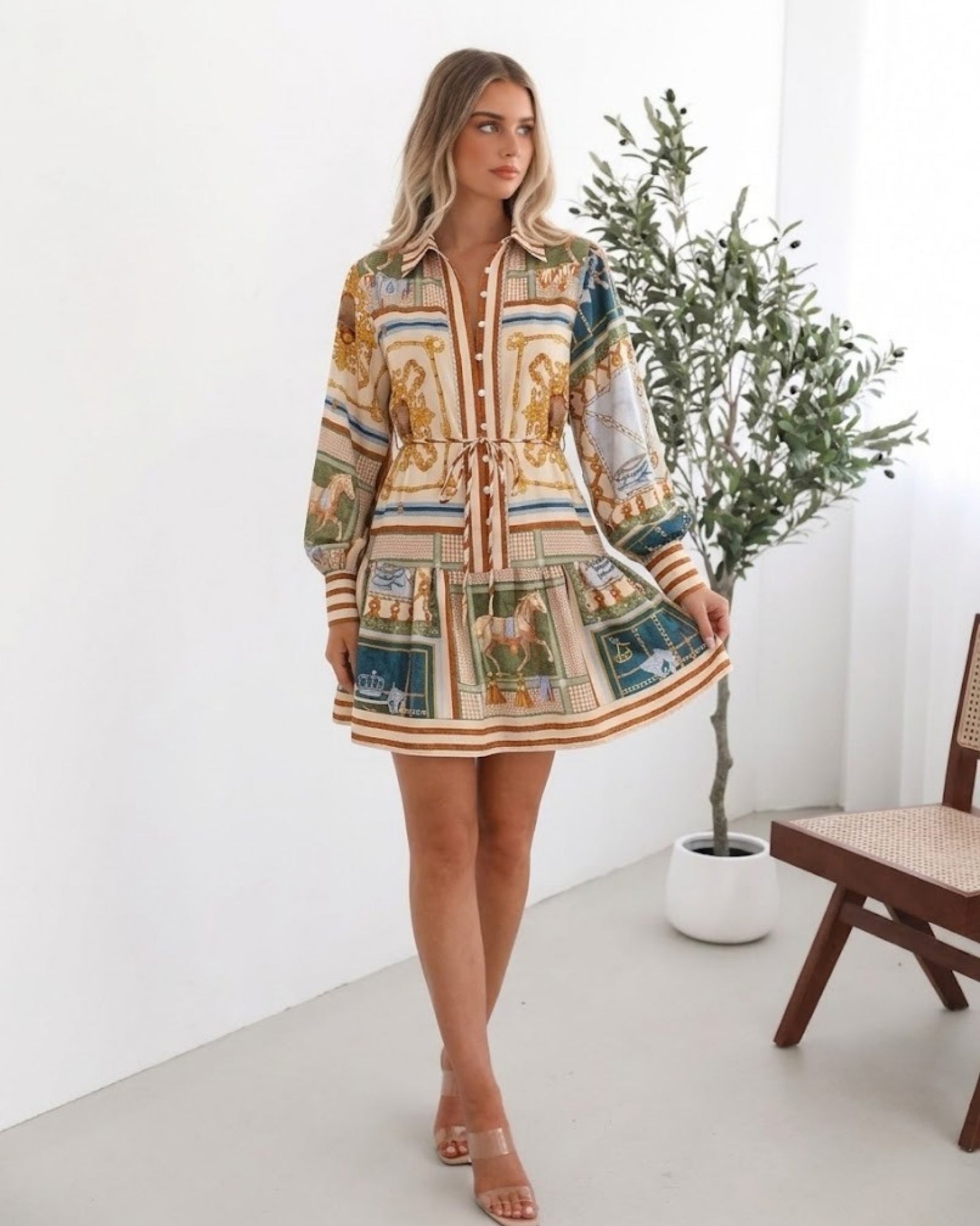 Women's bold print tiered mini dress styled for brunch by Esther & Co