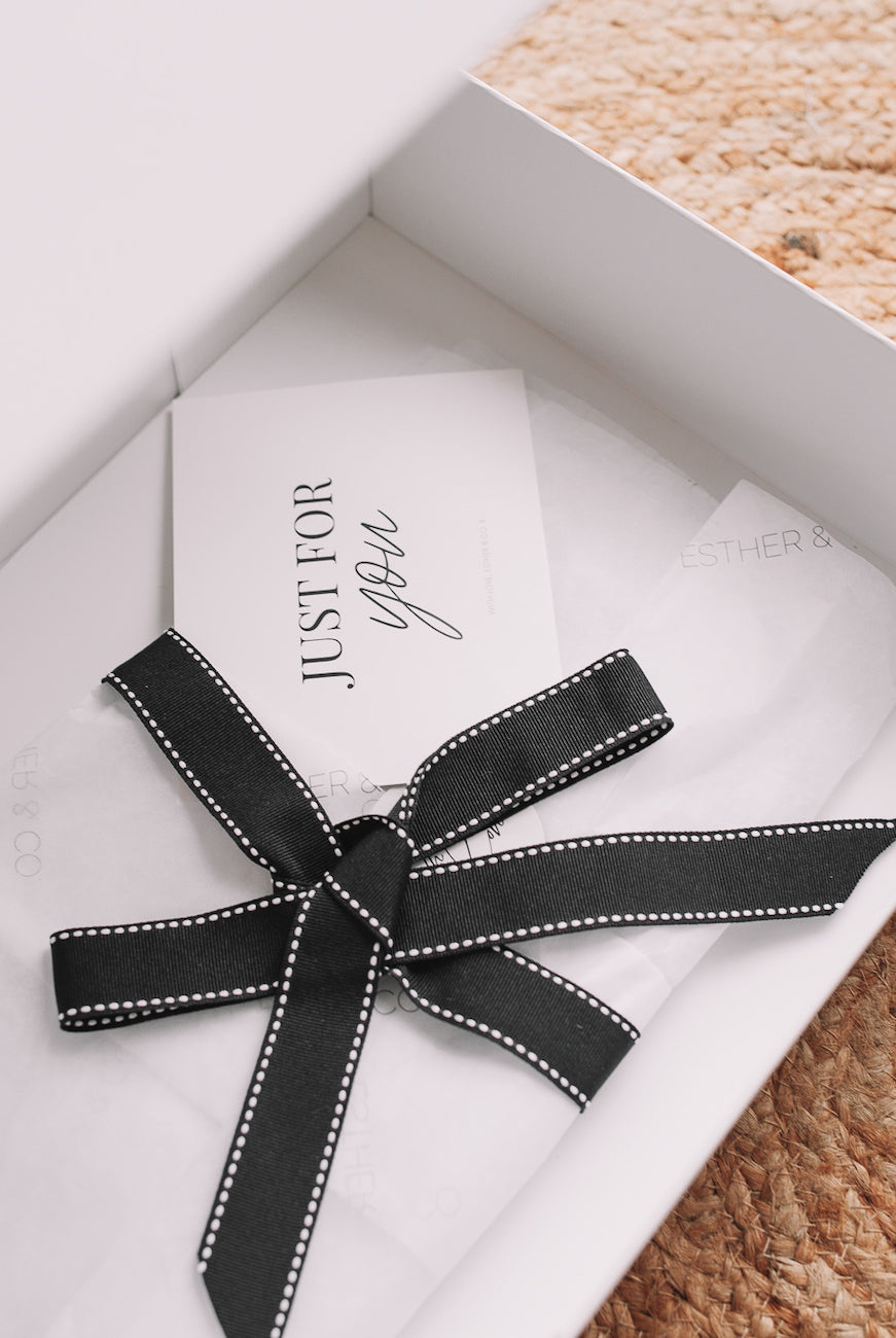 White gift wrapping with ribbon detail, Esther & Co gift wrapping