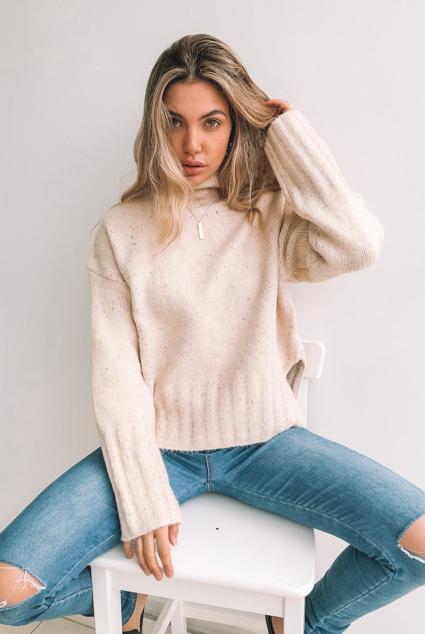 Women wearing the Chesterfield Jumper in Beige, a cosy heavyweight knit in neutral beige with mocha speckle detail