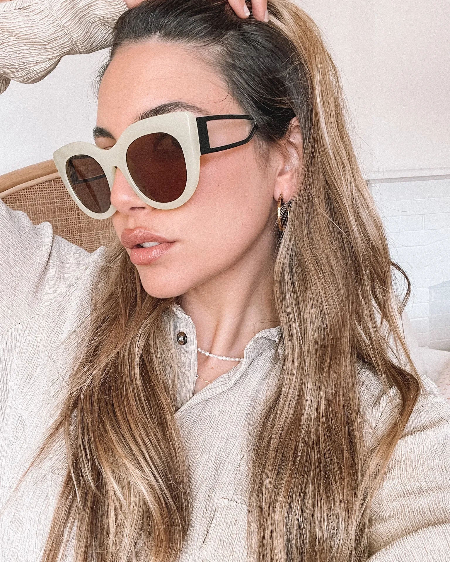 A pair of sunglasses with green frames and brown lenses displayed on a surface.