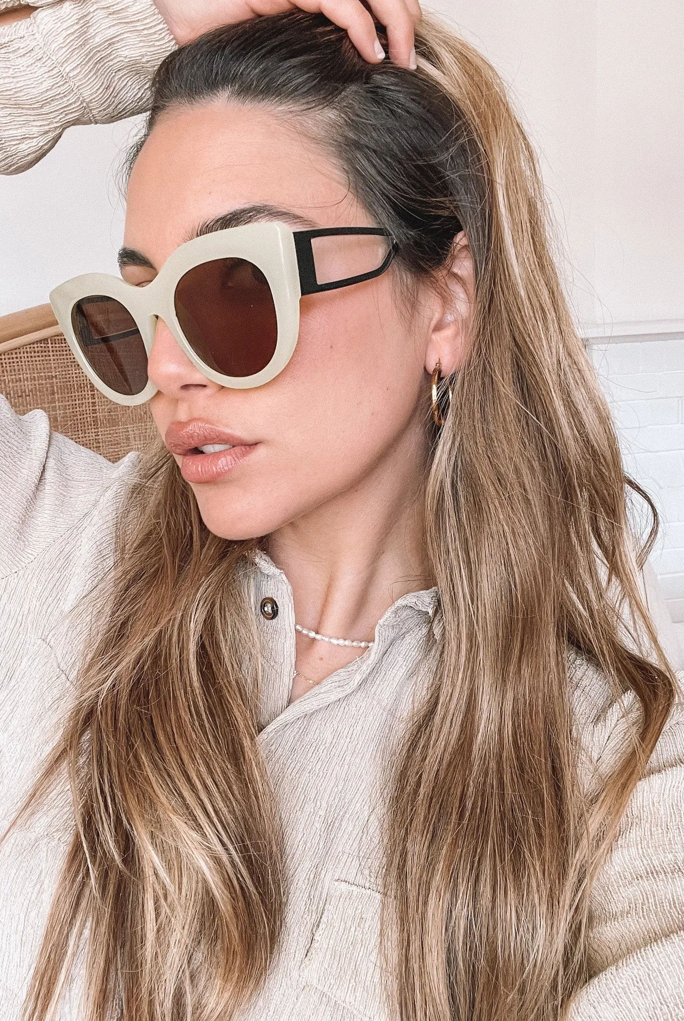 A pair of sunglasses with green frames and brown lenses displayed on a surface.