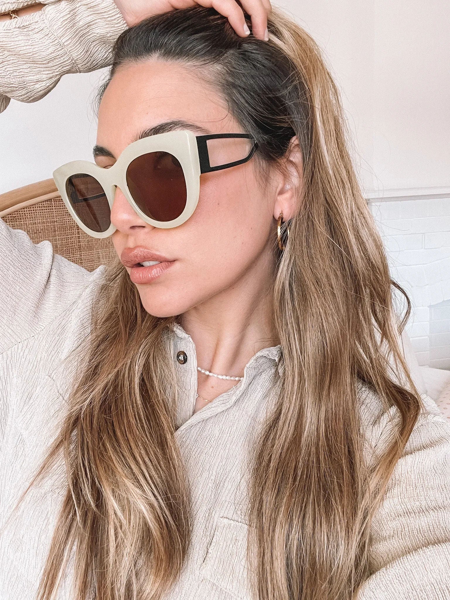A pair of sunglasses with green frames and brown lenses displayed on a surface.