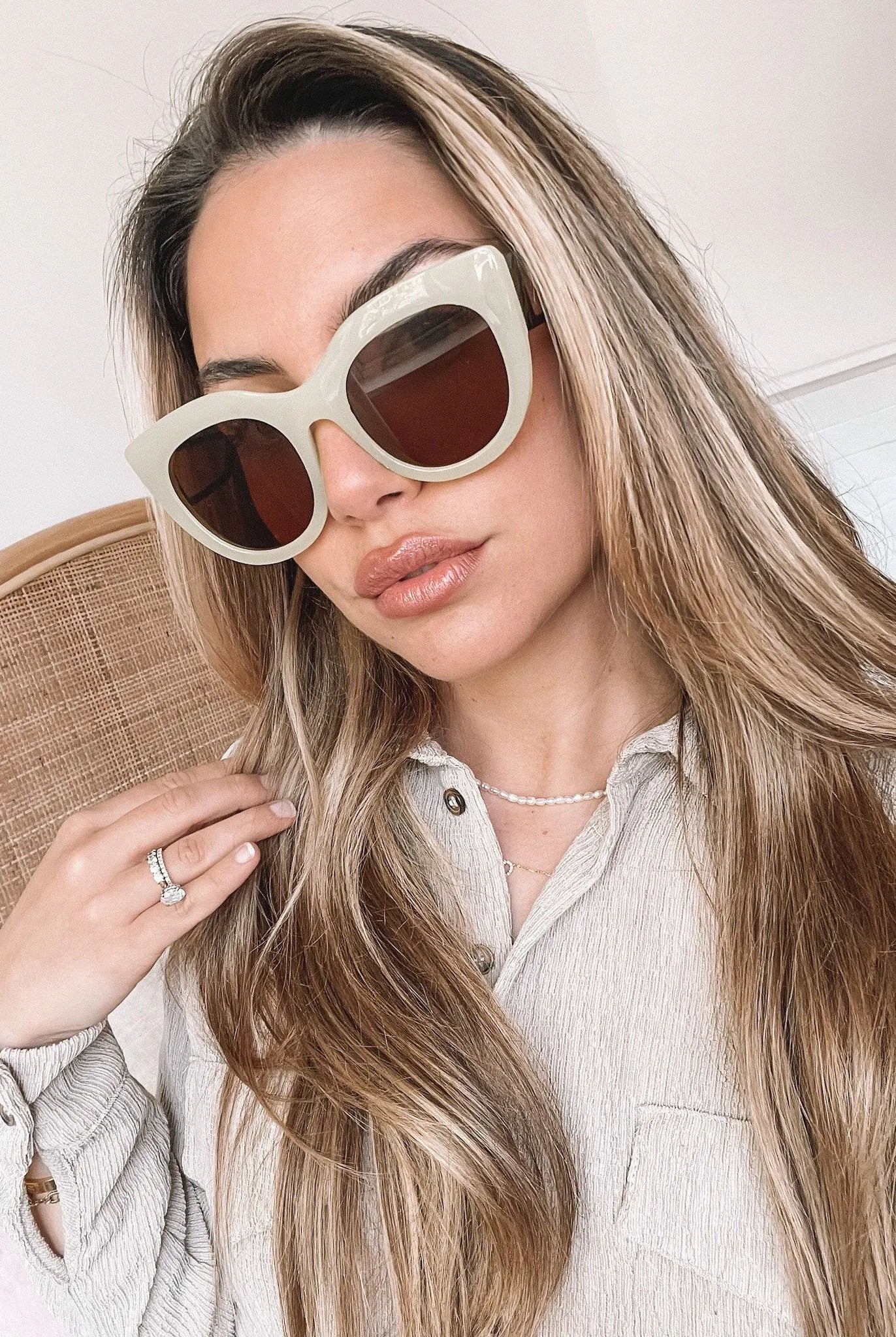 A pair of sunglasses with green frames and brown lenses displayed on a surface.