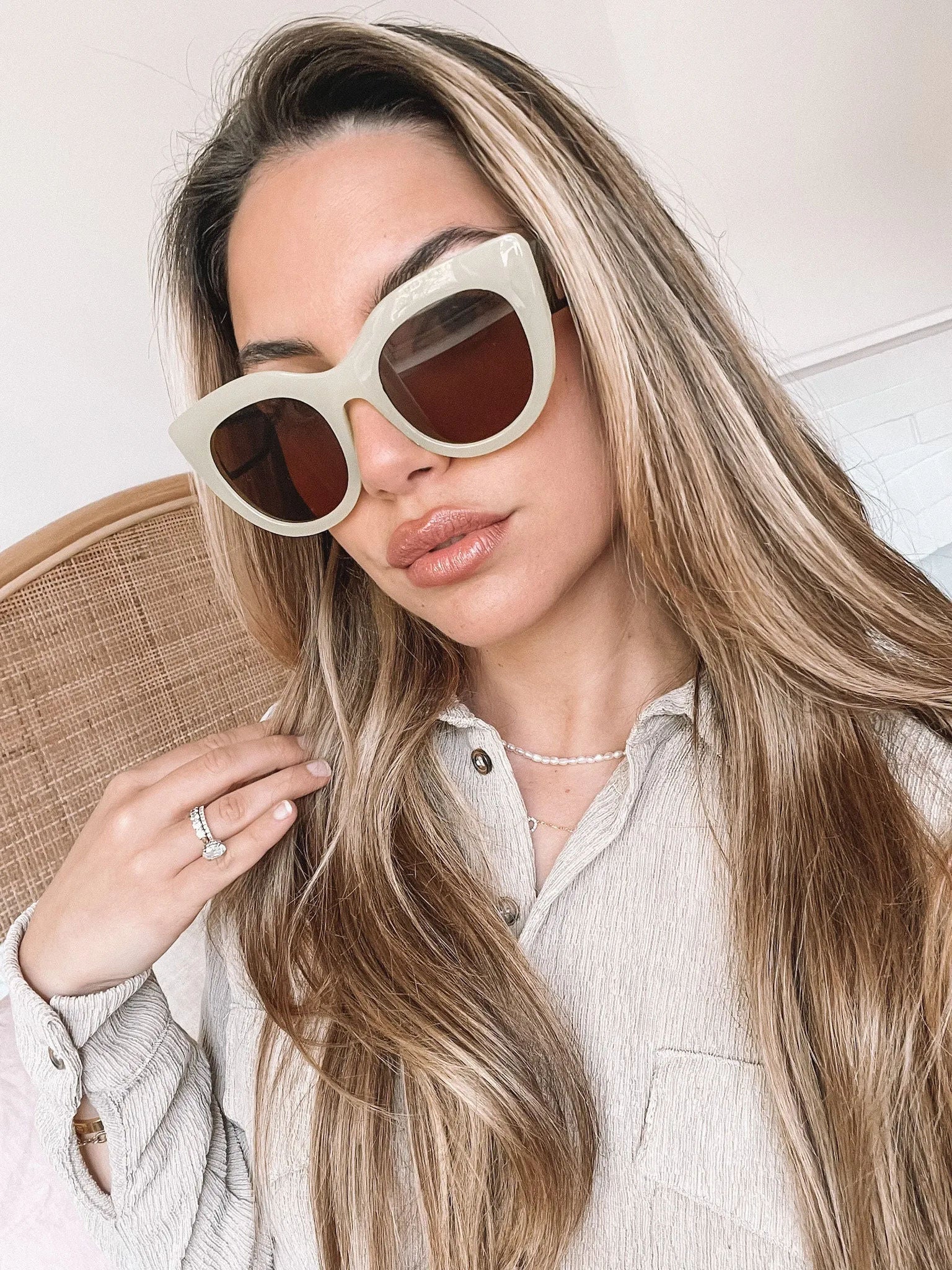 A pair of sunglasses with green frames and brown lenses displayed on a surface.