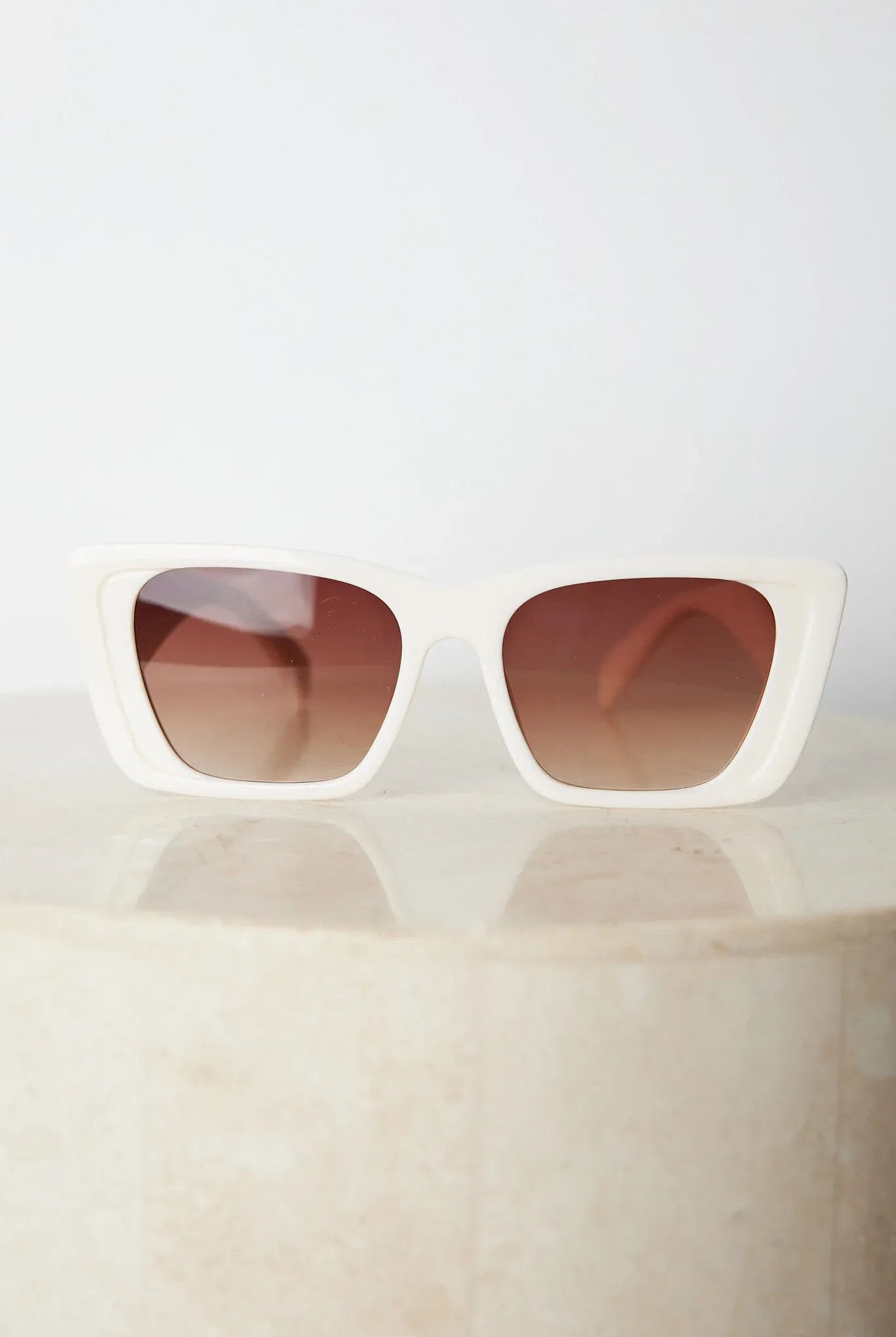 Beige frame sunglasses with dark lenses, the Calloway Sunglasses in Beige by Esther & Co